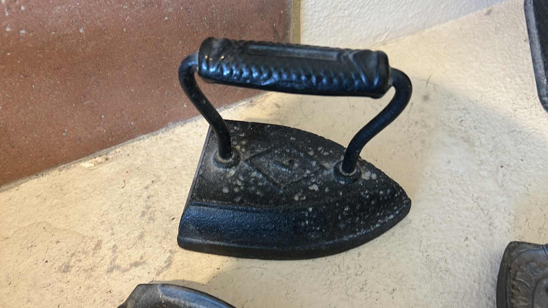 Photo 1 of ANTIQUE CAST IRON IRONS AND IRON TRIVETS. INCLUDES SAD IRONS AND DECORATIVE IRON RESTS