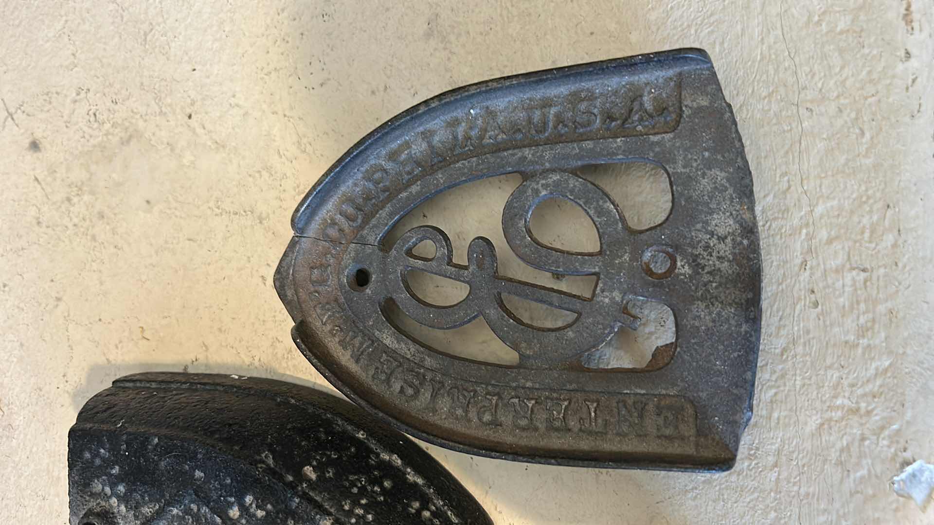 Photo 1 of ANTIQUE CAST IRON IRONS AND IRON TRIVETS. INCLUDES SAD IRONS AND DECORATIVE IRON RESTS