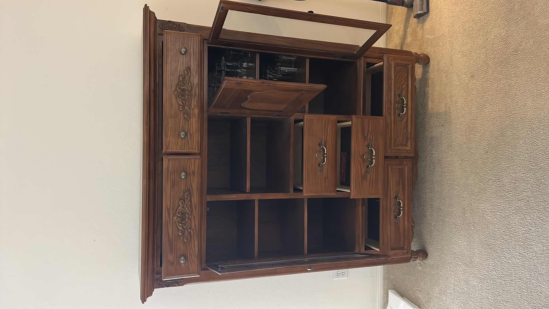 Photo 1 of TRADITIONAL CARVED WOOD HUTCH OR ARMOIRE, OFTEN REFERRED TO AS A CHINA CABINET. FEATURES DARK CHERRY OR WALNUT FINISH WITH GLASS-PANELED DOORS AND DRAWERS FOR STORAGE. 54 1/2” x 19” x H65” TONGUE AND GROOVE