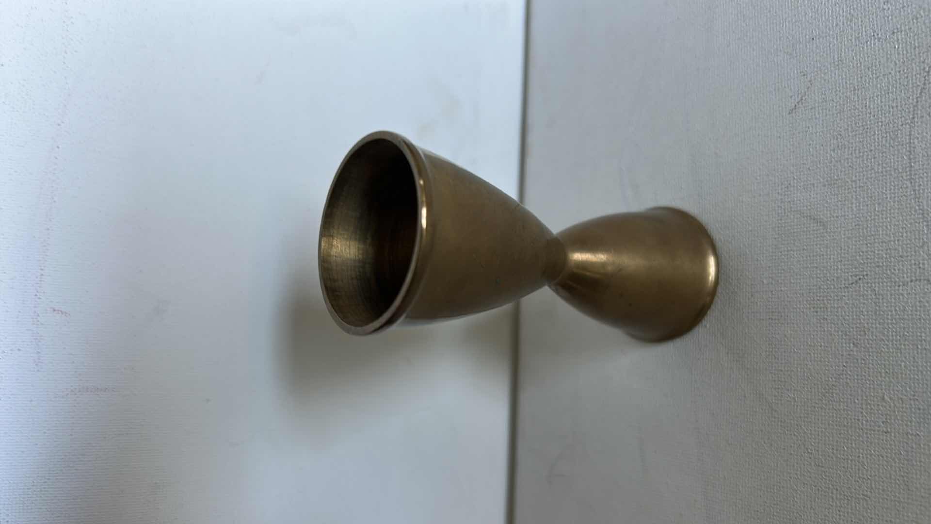 Photo 1 of BRASS CANDLE HOLDERS AND CANDLE ACCESSORIES. INCLUDES MULTIPLE TALL TAPER HOLDERS, A MULTI-ARM CANDELABRA H10” AND A BRASS CUP.