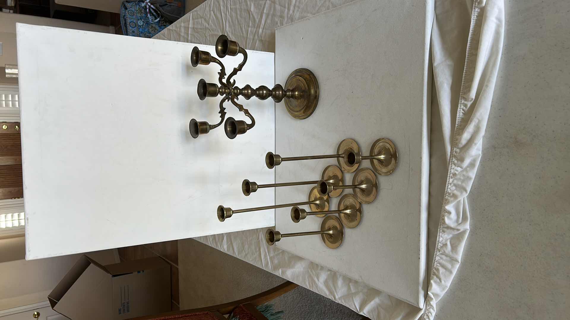Photo 1 of BRASS CANDLE HOLDERS AND CANDLE ACCESSORIES. INCLUDES MULTIPLE TALL TAPER HOLDERS, A MULTI-ARM CANDELABRA H10” AND A BRASS CUP.
