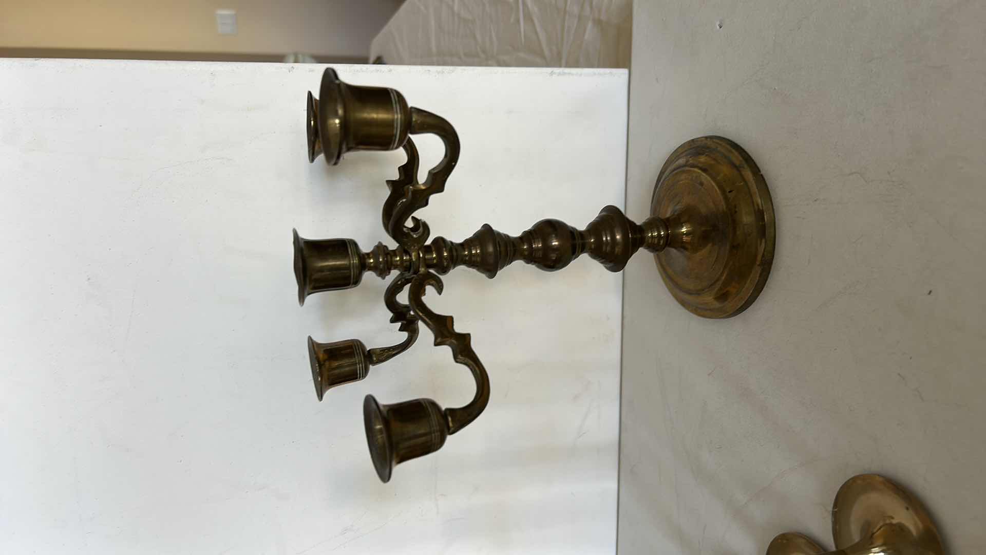 Photo 1 of BRASS CANDLE HOLDERS AND CANDLE ACCESSORIES. INCLUDES MULTIPLE TALL TAPER HOLDERS, A MULTI-ARM CANDELABRA H10” AND A BRASS CUP.