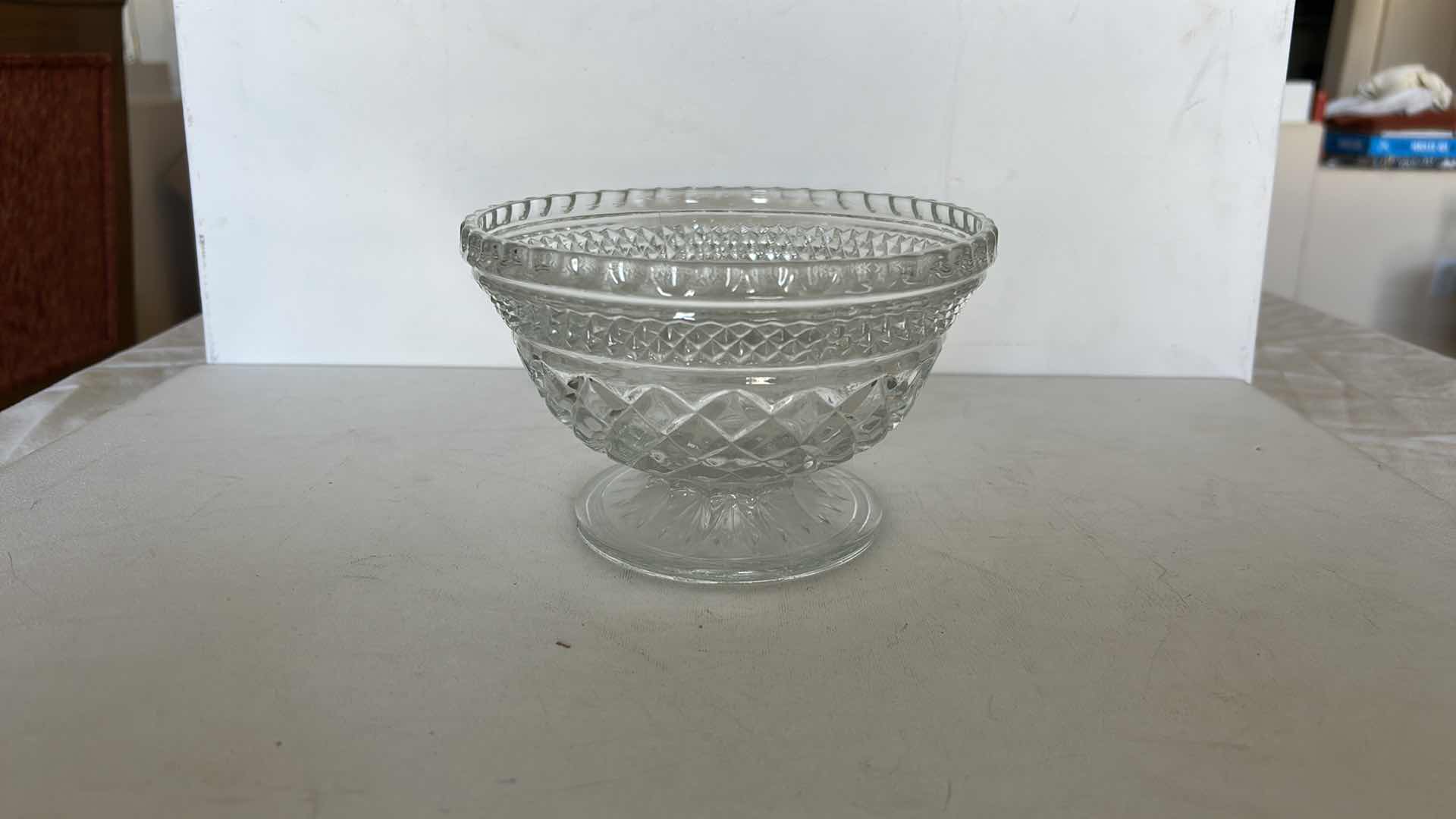 Photo 1 of SET OF TWO CLEAR PRESSED GLASS BOWLS. ONE OVAL SERVING BOWL AND ONE PEDESTAL BOWL H4.25”WITH CUT PATTERN DESIGN.