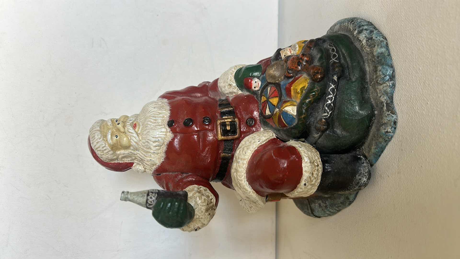 Photo 1 of CAST IRON VINTAGE SANTA CLAUSE HOLDING COCA COLA H8”