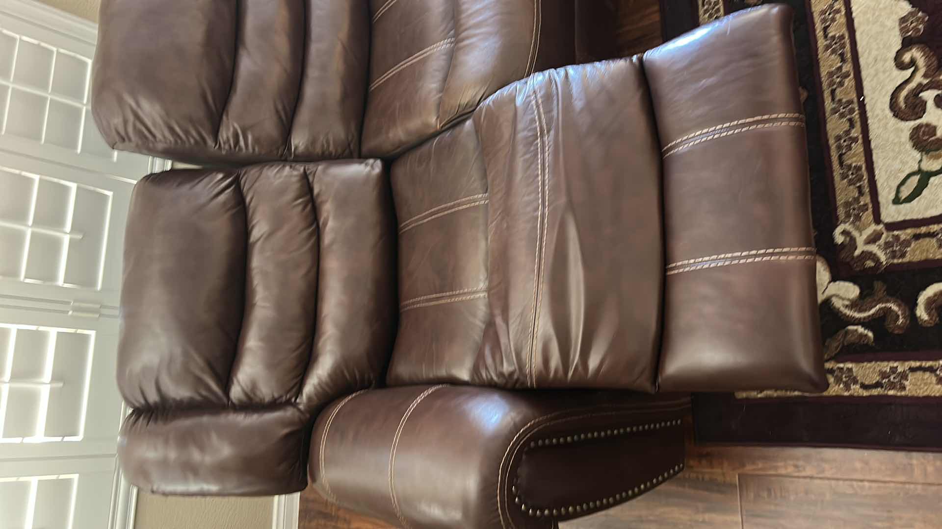 Photo 1 of 7 1/2’ POWER RECLINING LEATHER LOOK SOFA FEATURING CONTRASTING STITCHING, POWER RECLINE FUNCTIONALITY ON THE END SEATS,