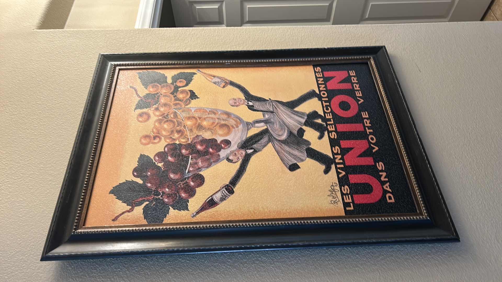 Photo 1 of FRAMED VINTAGE SIGNED ADVERTISEMENT TITLED “LES VINS SELECTIONNES UNION DANS VOTRE VERRE,” DESIGNED BY ROBERT WOLFF. 30” x H42”