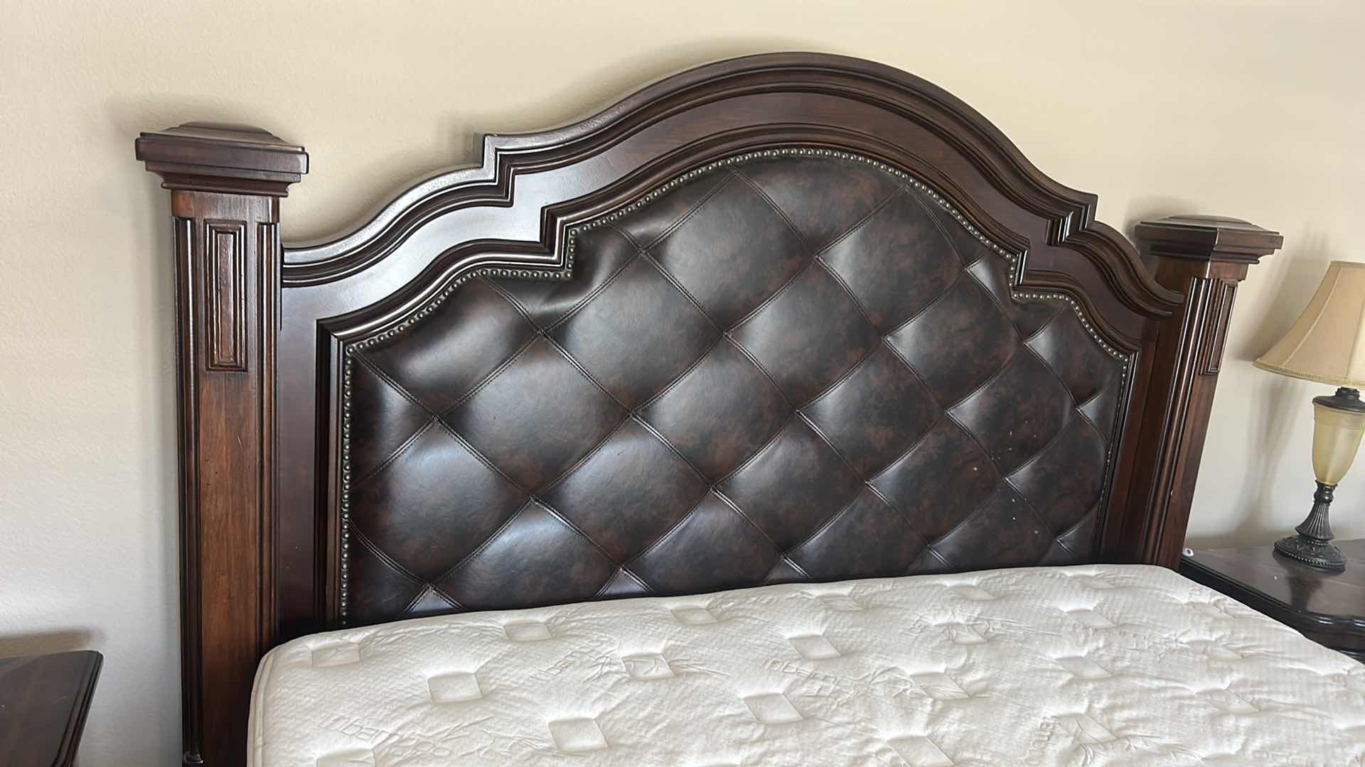 Photo 1 of HOMELEGANCE ADELINA COLLECTION PANEL BED, FEATURING A CHERRY FINISH, FAUX LEATHER UPHOLSTERED HEADBOARD WITH BUTTON TUFTING, AND INTRICATE WOOD CARVINGS. 7‘ x 8‘ x H6‘ $2200