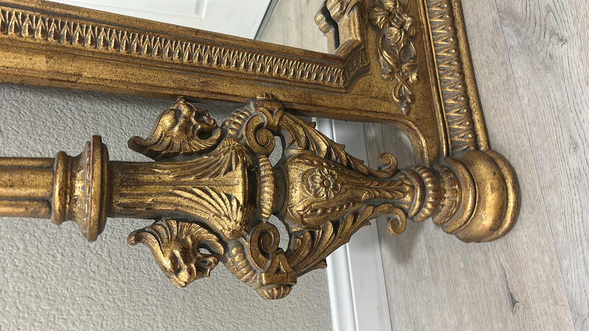 Photo 1 of ITALIAN BAROQUE-STYLE FIGURAL MIRROR FEATURING A GOLD GILT FINISH, A LARGE CENTRAL FEMALE FACE CREST, AND WINGED GRIFFINS ON THE BASE. 25” x H53“
