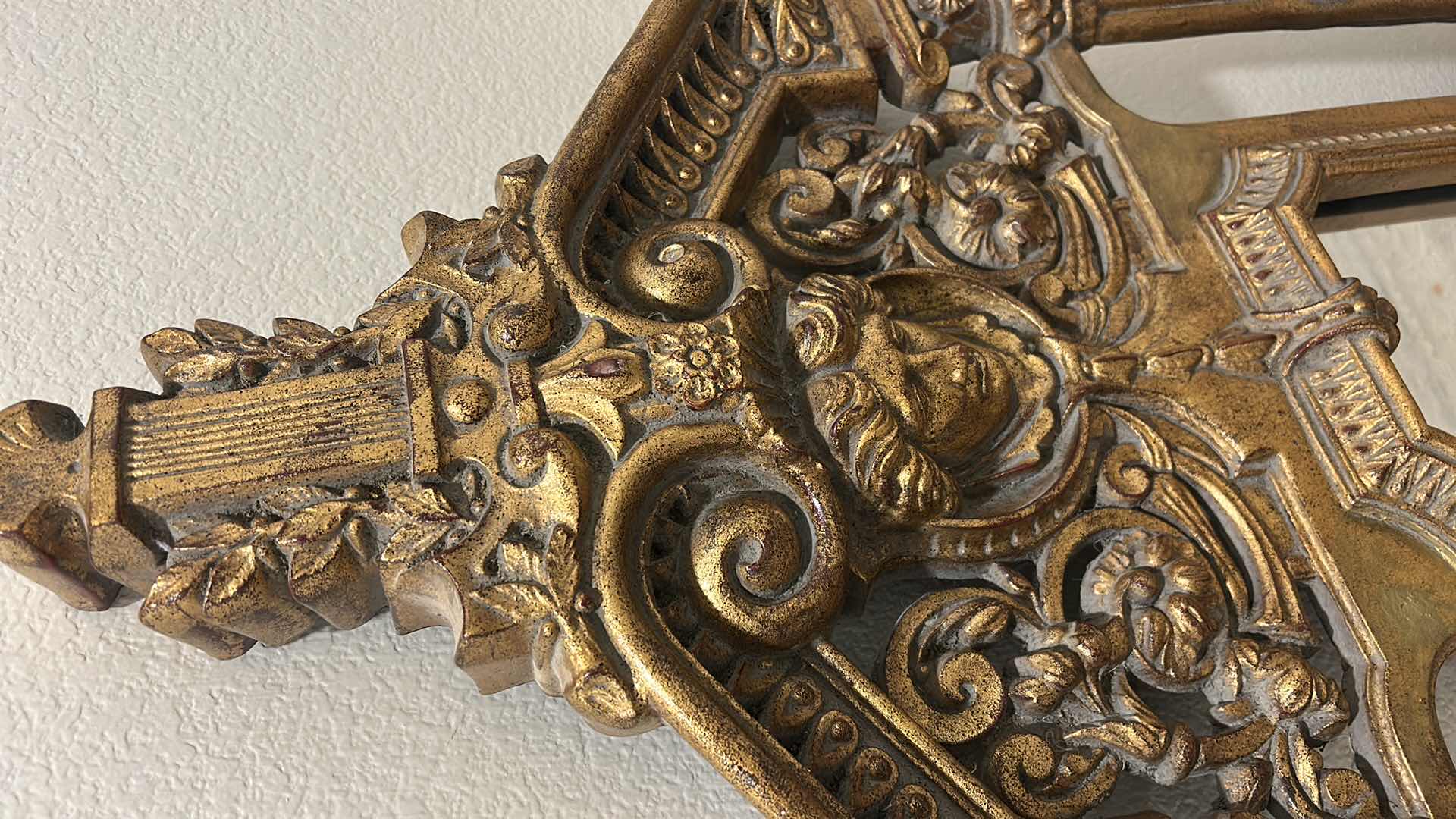 Photo 1 of ITALIAN BAROQUE-STYLE FIGURAL MIRROR FEATURING A GOLD GILT FINISH, A LARGE CENTRAL FEMALE FACE CREST, AND WINGED GRIFFINS ON THE BASE. 25” x H53“