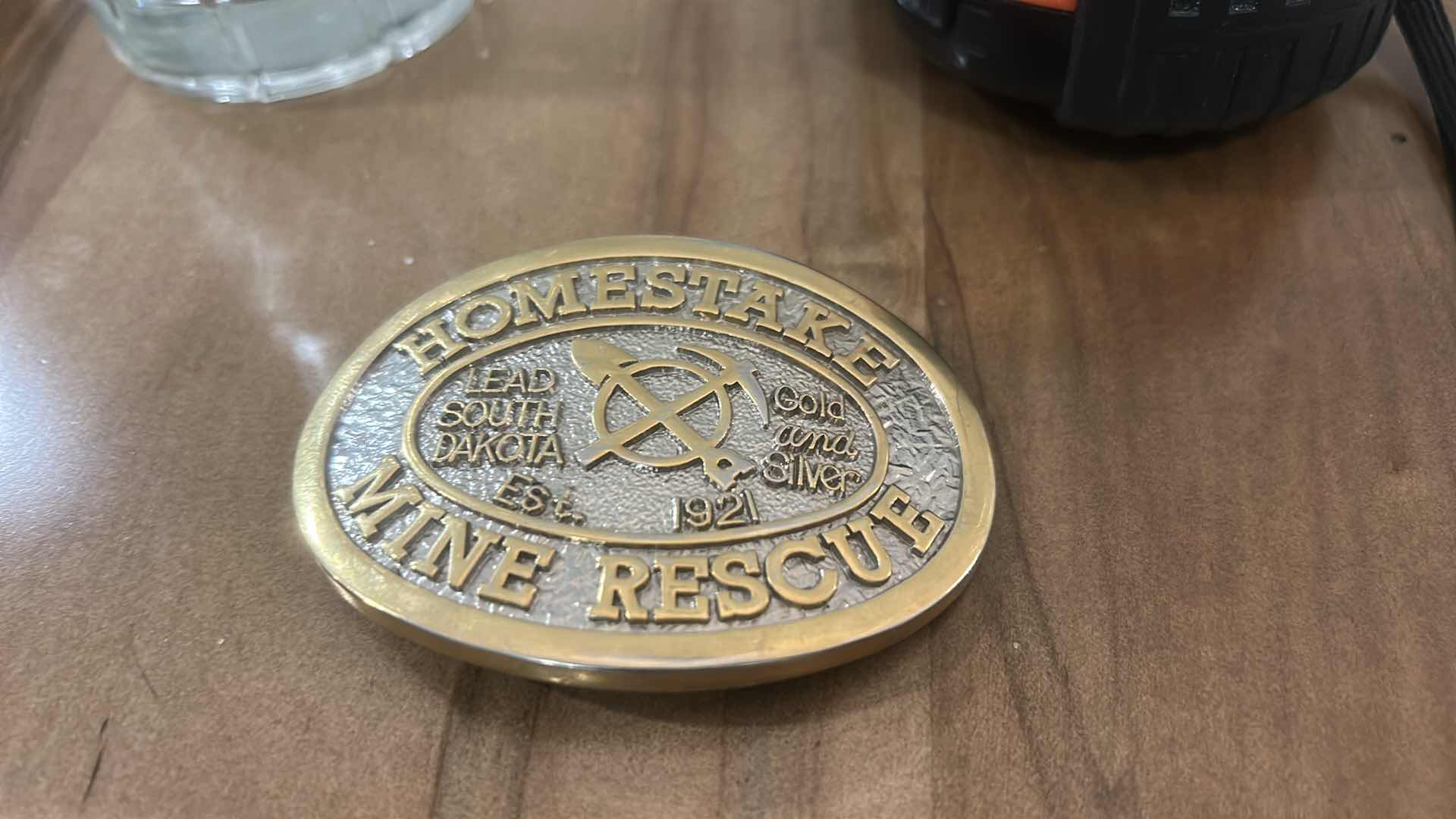 Photo 1 of COLLECTIBLE BELT BUCKLE COMMEMORATING THE HOMESTAKE MINE RESCUE TEAM IN LEAD, SOUTH DAKOTA, ESTABLISHED IN 1921.