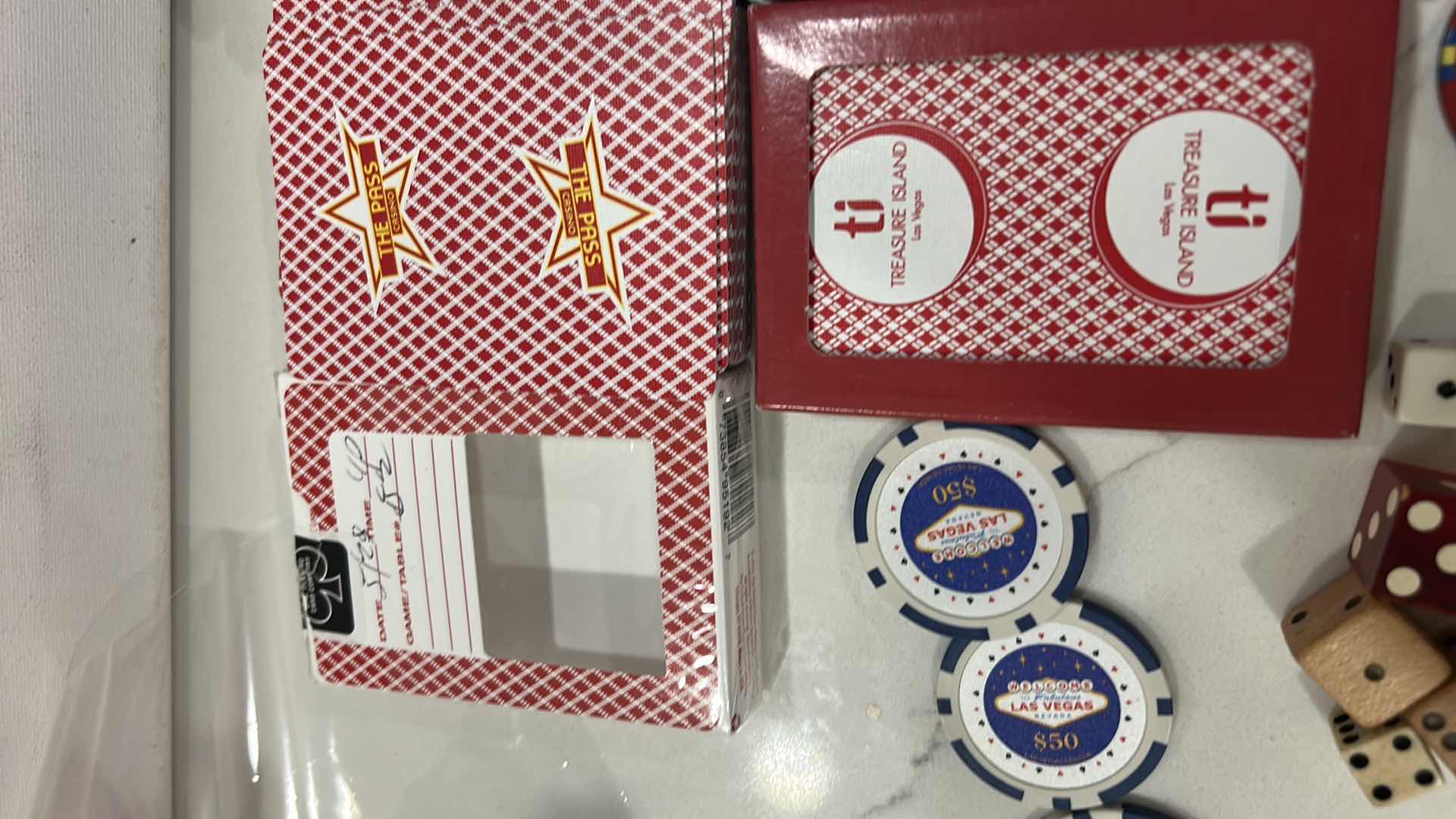 Photo 1 of LAS VEGAS CASINO PLAYING CARDS, DICE, 6 $50 REPLICA CHIPS AND 1 REAL CHIP, 1 COMMEMORATIVE TOKEN