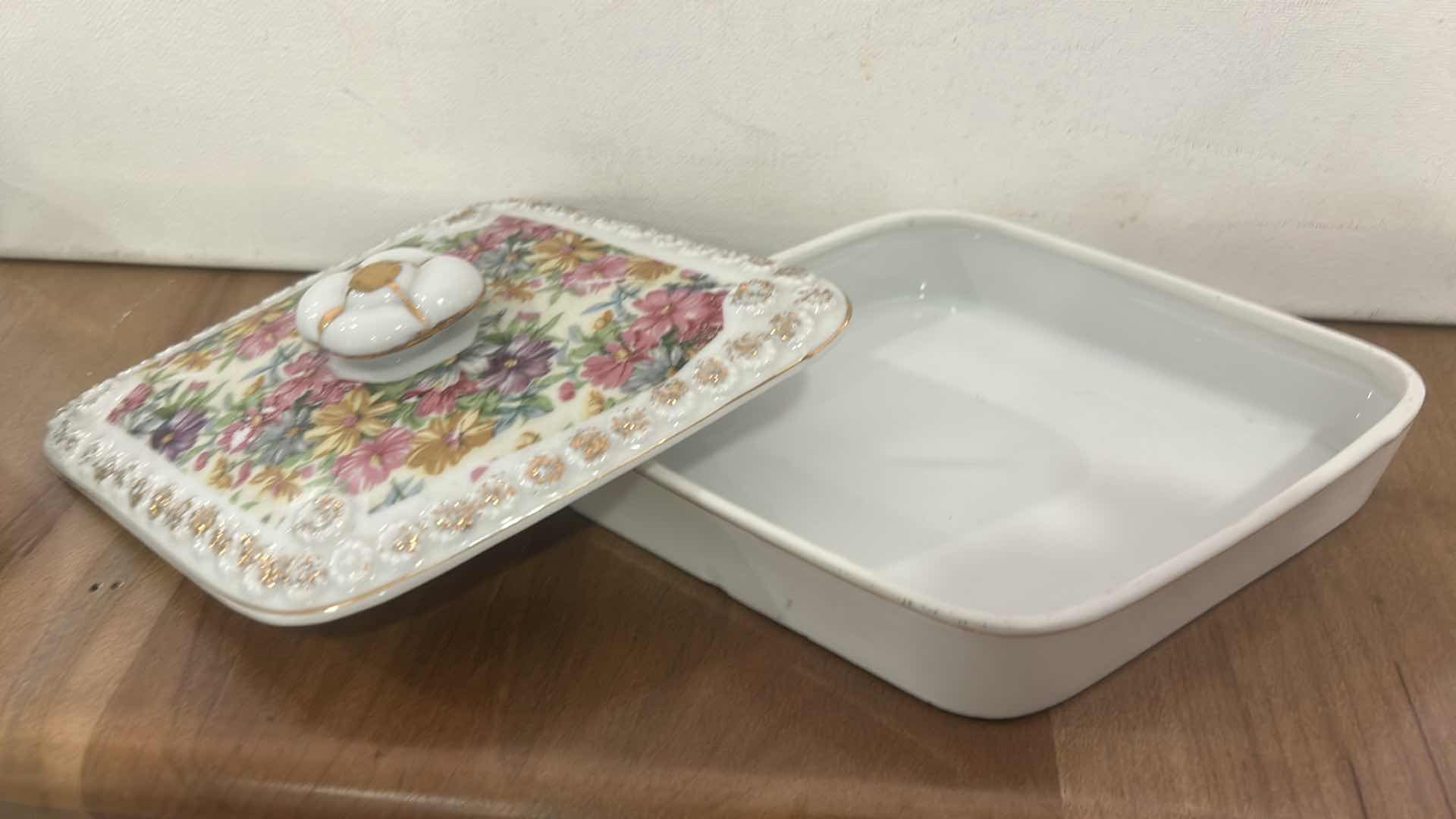 Photo 1 of VINTAGE DIAMOND-SHAPED PORCELAIN TRINKET BOX WITH FLORAL PATTERN ON LID.