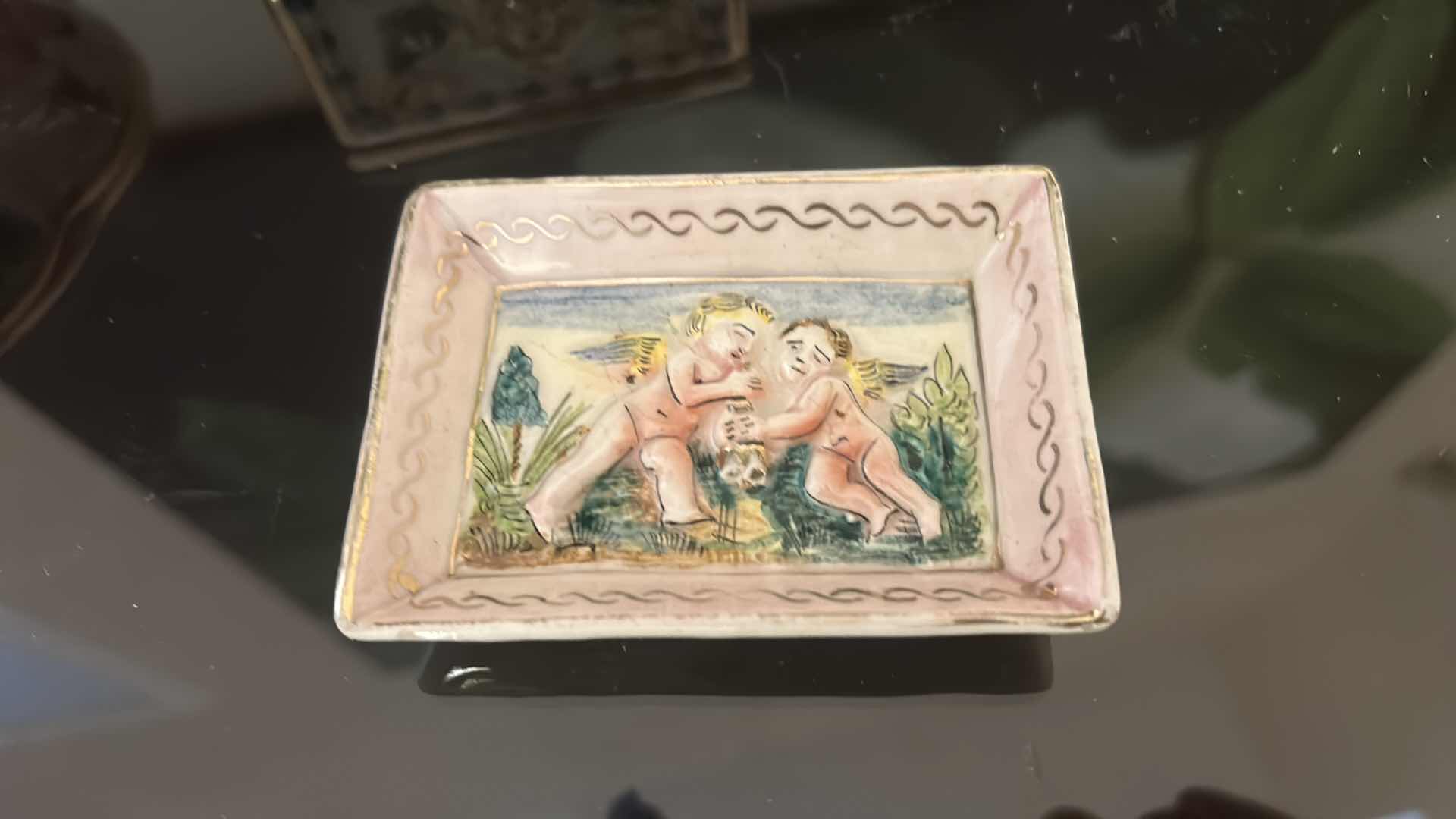 Photo 1 of ANTIQUE CAPODIMONTE ITALIAN PORCELAIN DRESSER SET FEATURING RAISED RELIEF DESIGNS OF CHERUBS .
•THE SET INCLUDES A LARGE LIDDED BOX, A SMALLER LIDDED JEWELRY BOX, AND A SMALL OPEN TRAY. LARGEST 9 1/4” x 7 1/4” x H5 1/2”