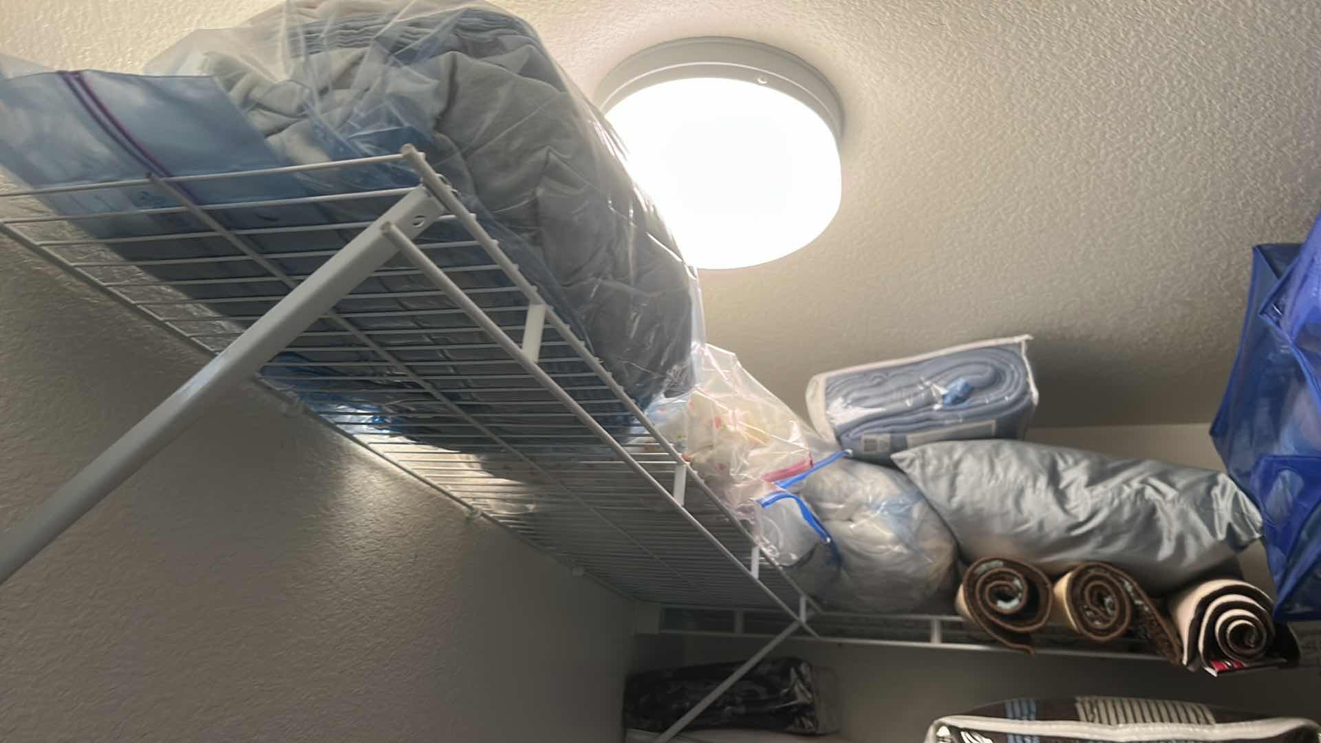 Photo 1 of BEDDING, CHAIR COVERS, RUGS AND MORE ON SHELVES IN CLOSET