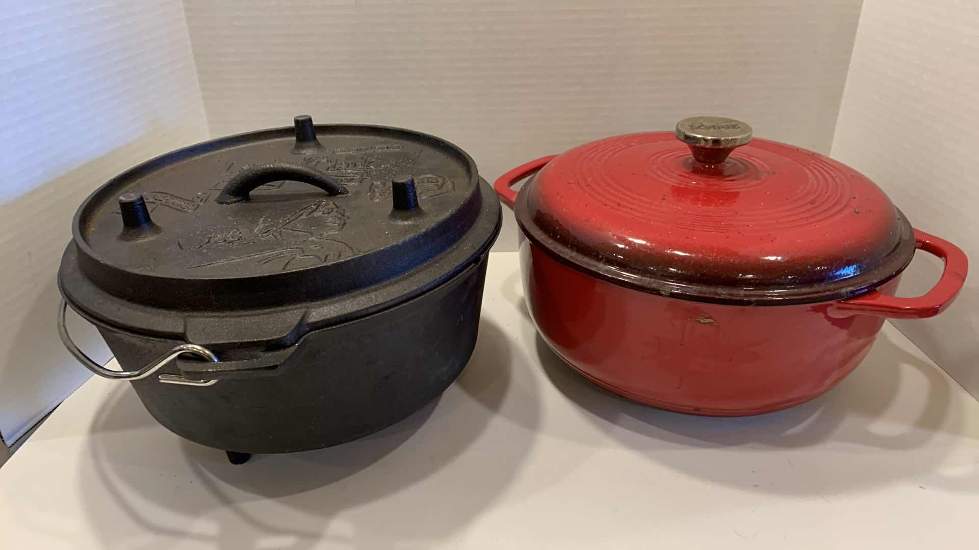 Photo 1 of 2-CAST IRON COOKWARE PIECES, LODGE AND LEWIS AND CLARK 6 QT