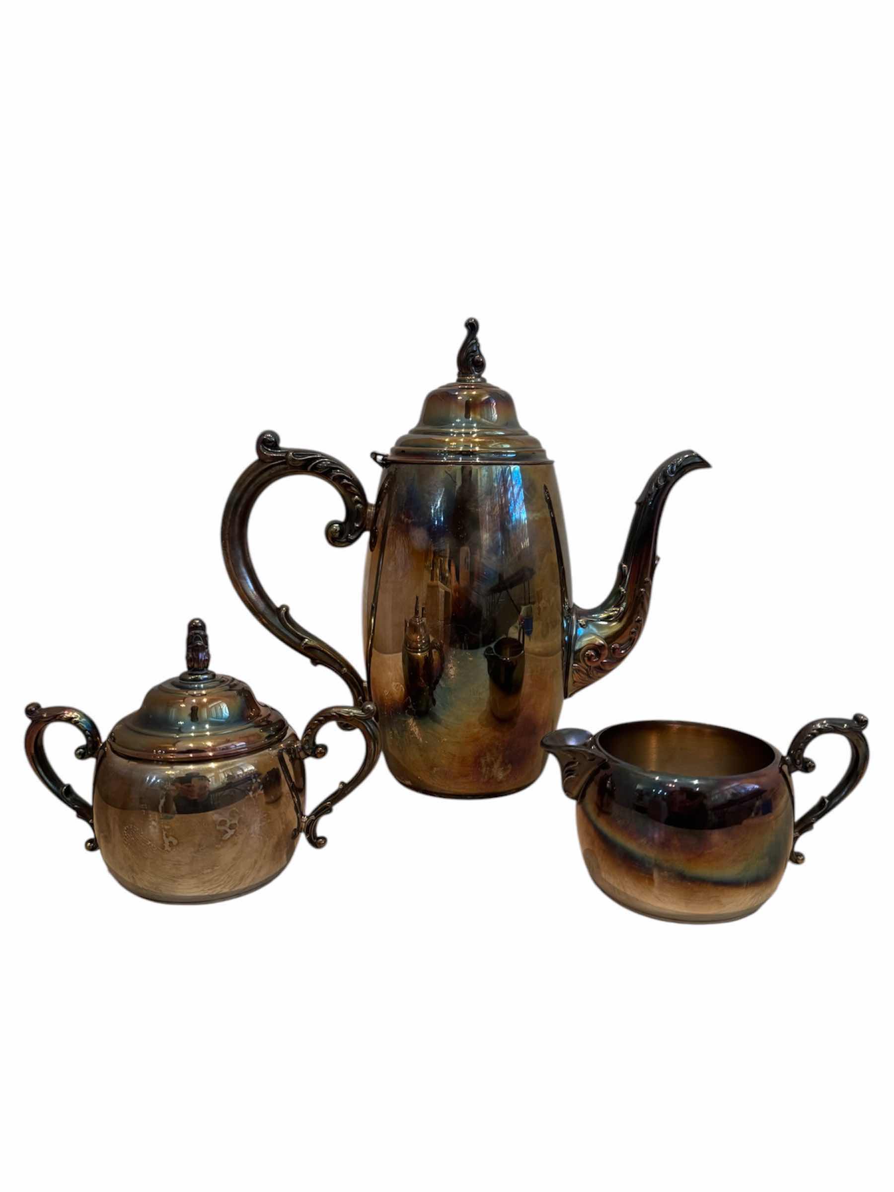 Photo 1 of VINTAGE ANTIQUE SILVER PLATED TEA SET, WM A. ROGERS
TEA POT - 10” X H9.5”,
CREAMER - 5” X H2.5”,
SUGAR BOWL - 5.5” X H4”