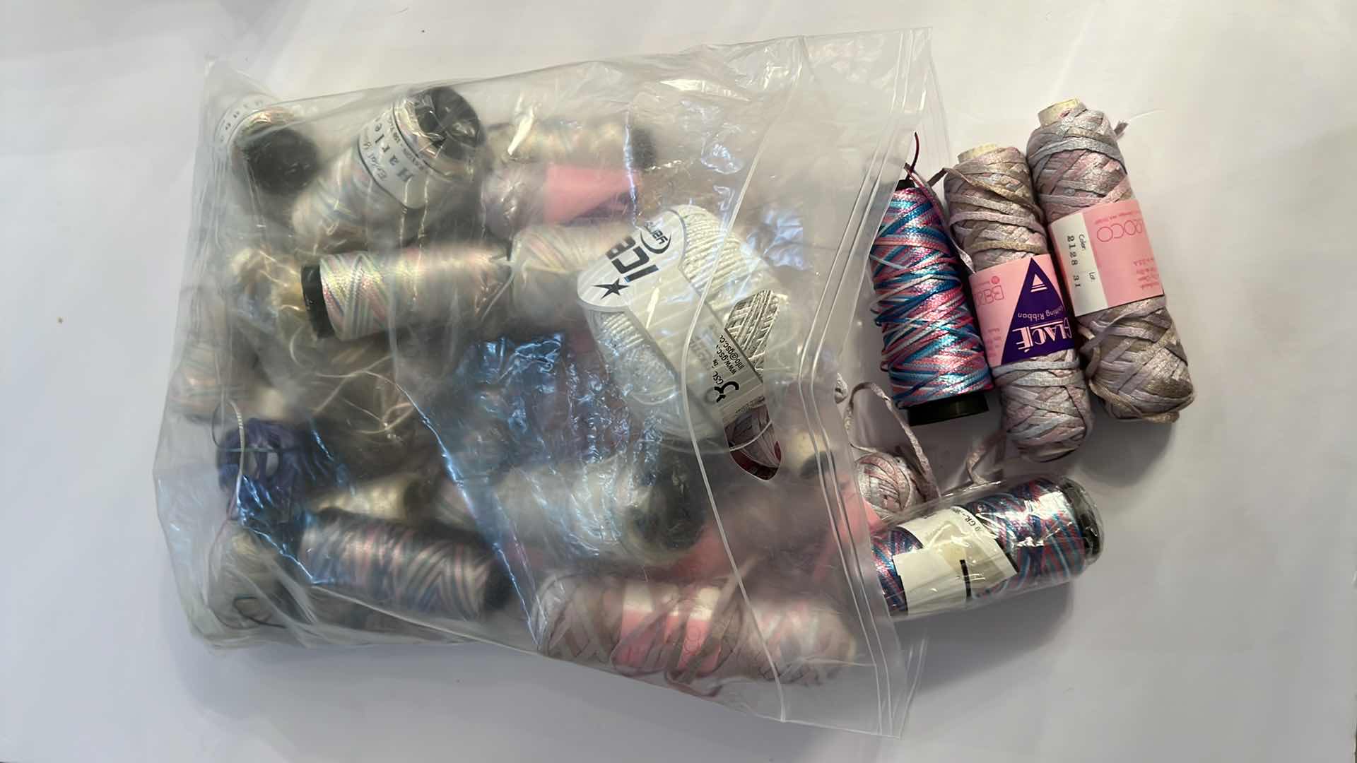 Photo 1 of BAG OF BOBBINS AND SKEINS OF KNITTING RIBBON AND THREAD