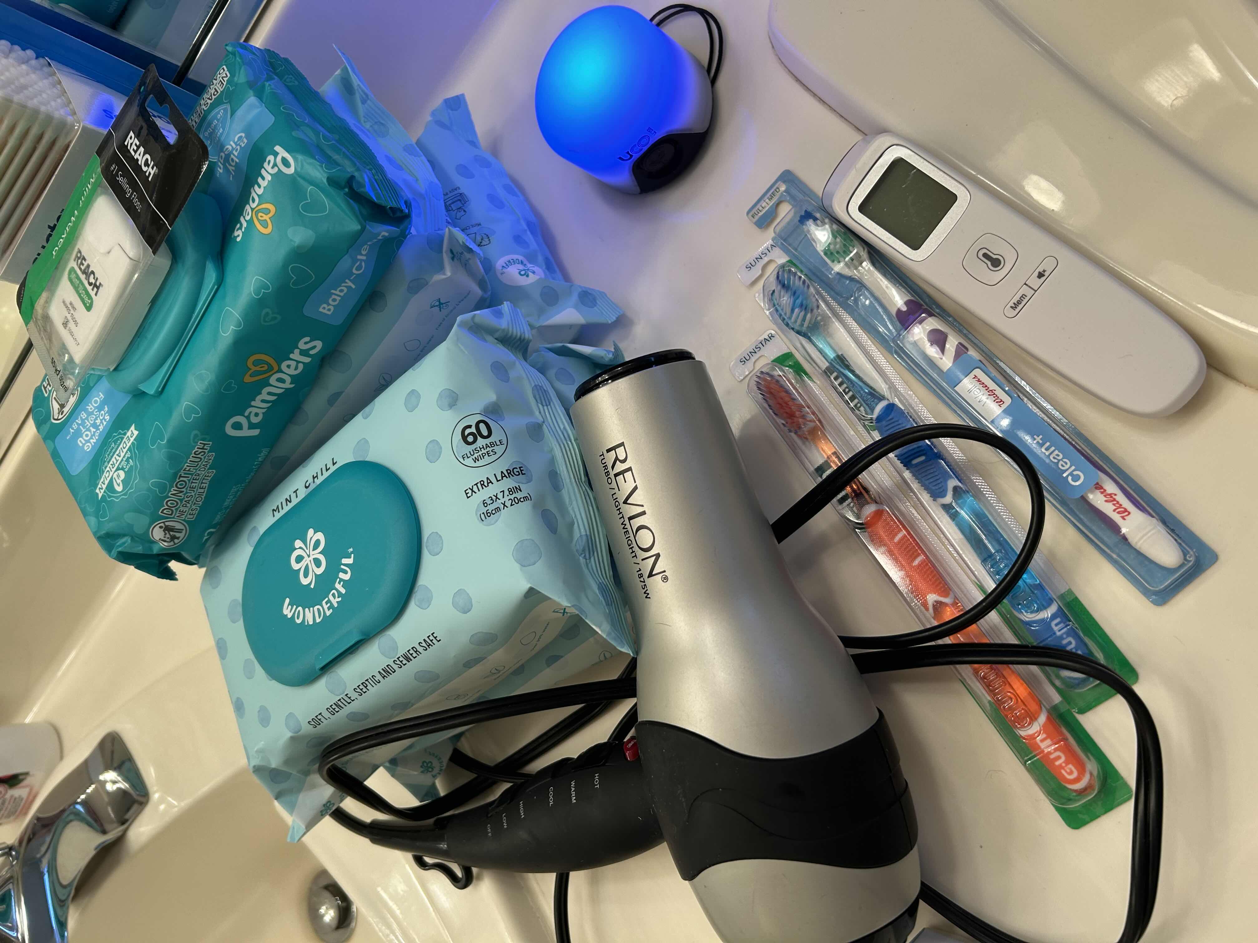Photo 1 of BATHROOM SUNDRIES.REVLON HAIRDRYER, DIGITAL THERMOMETER, PULSEOXIMETER, BRAND NEW-BABY WIPES, DENTAL FLOSS, TOOTHBRUSHES.