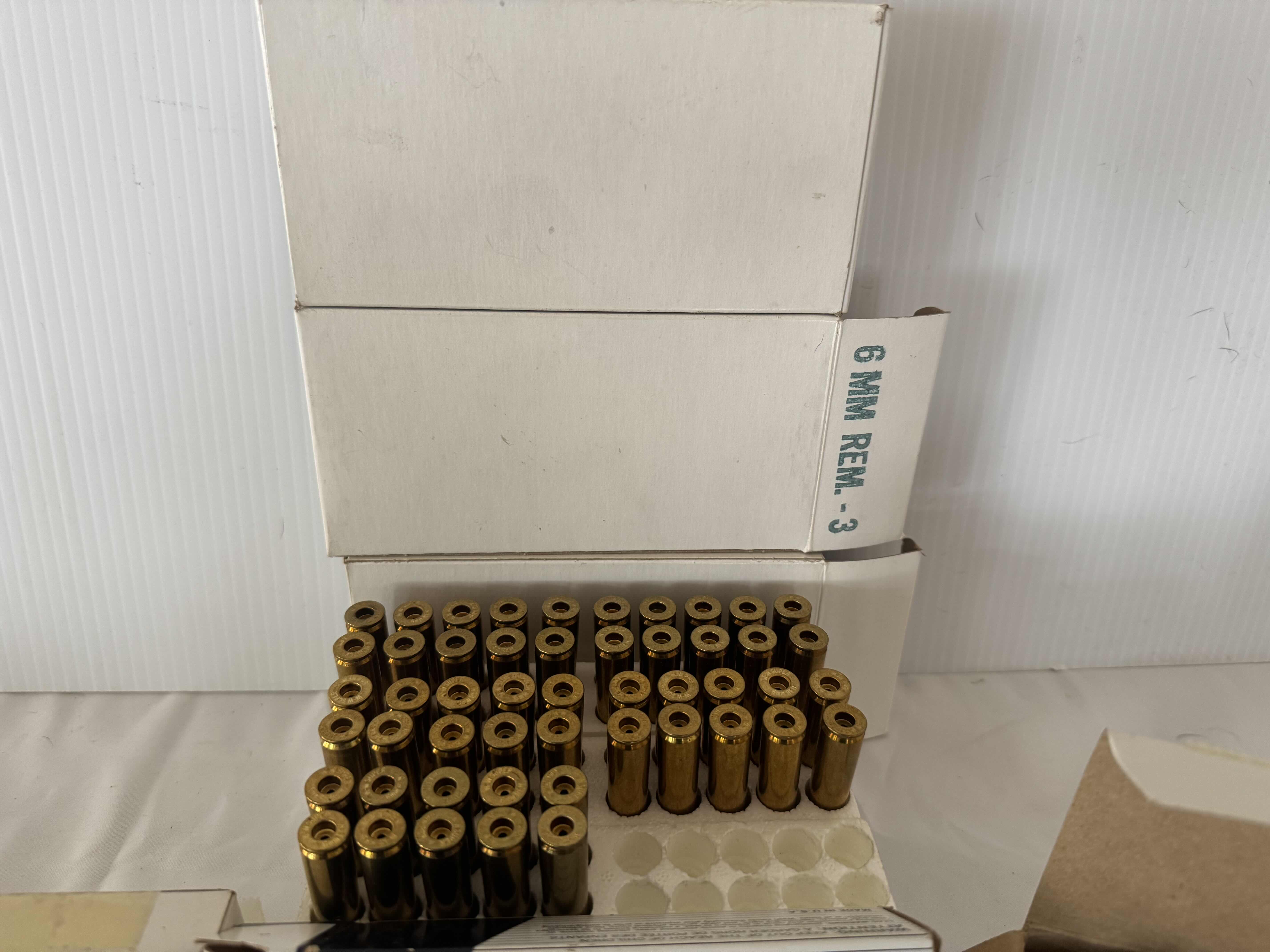 Photo 1 of ASSORTED BRASS CARTRIDGES. CCI SHOTSHELLS. GOLD MEDAL PISTOL CARTRIDGES-6MM REMINGTON, FIREARM AND GUN AMMUNITION ACCESSORIES.