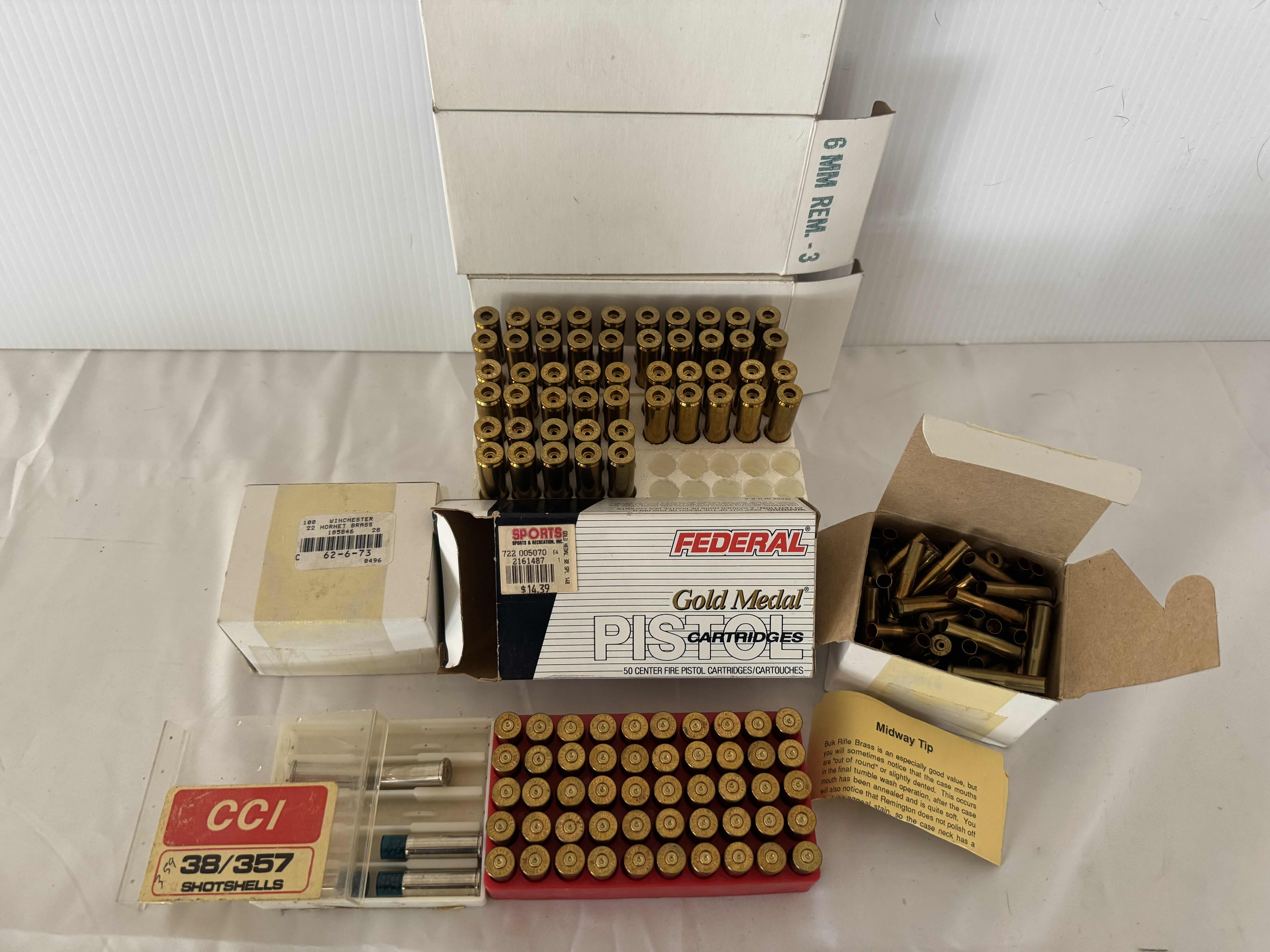 Photo 1 of ASSORTED BRASS CARTRIDGES. CCI SHOTSHELLS. GOLD MEDAL PISTOL CARTRIDGES-6MM REMINGTON, FIREARM AND GUN AMMUNITION ACCESSORIES.