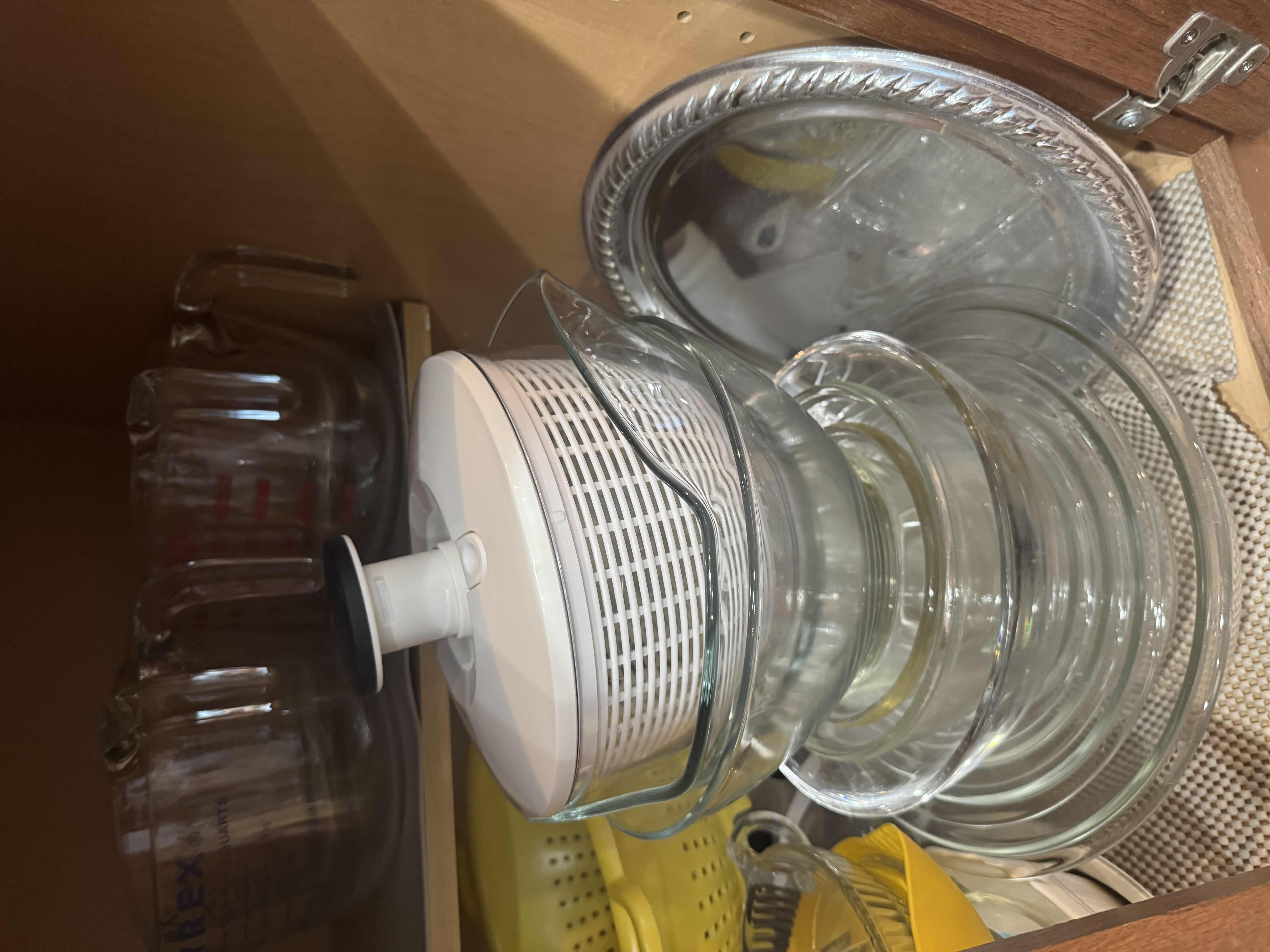 Photo 1 of CONTENTS OF CABINET: MIXING BOWLS, MEASURING CUPS, COLANDER,SALAD SPINNER
