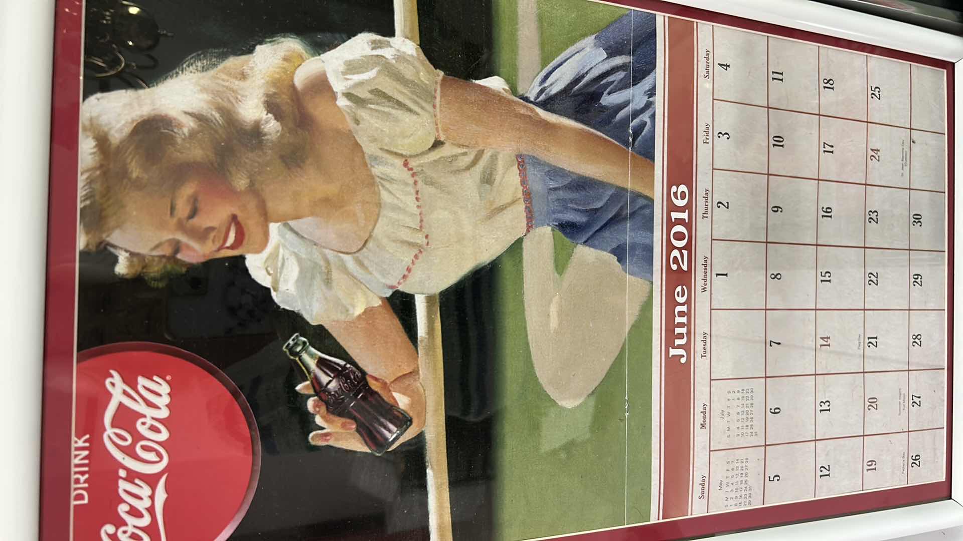View 2 of THREE VINTAGE FRAMED COCA COLA ADVERTISING CALENDAR PAGES FROM 2016/2017
15" X 26" 15" X 21"