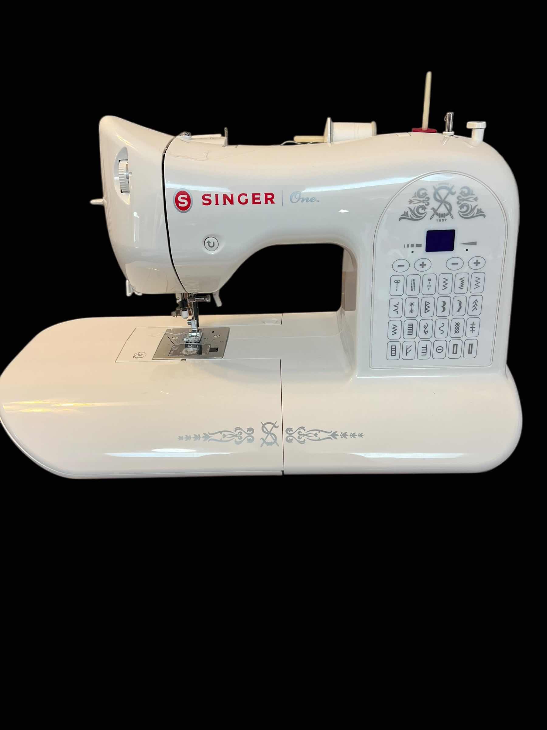 Photo 1 of SINGER SEWING MACHING WITH INSTRUCTION BOOK.
