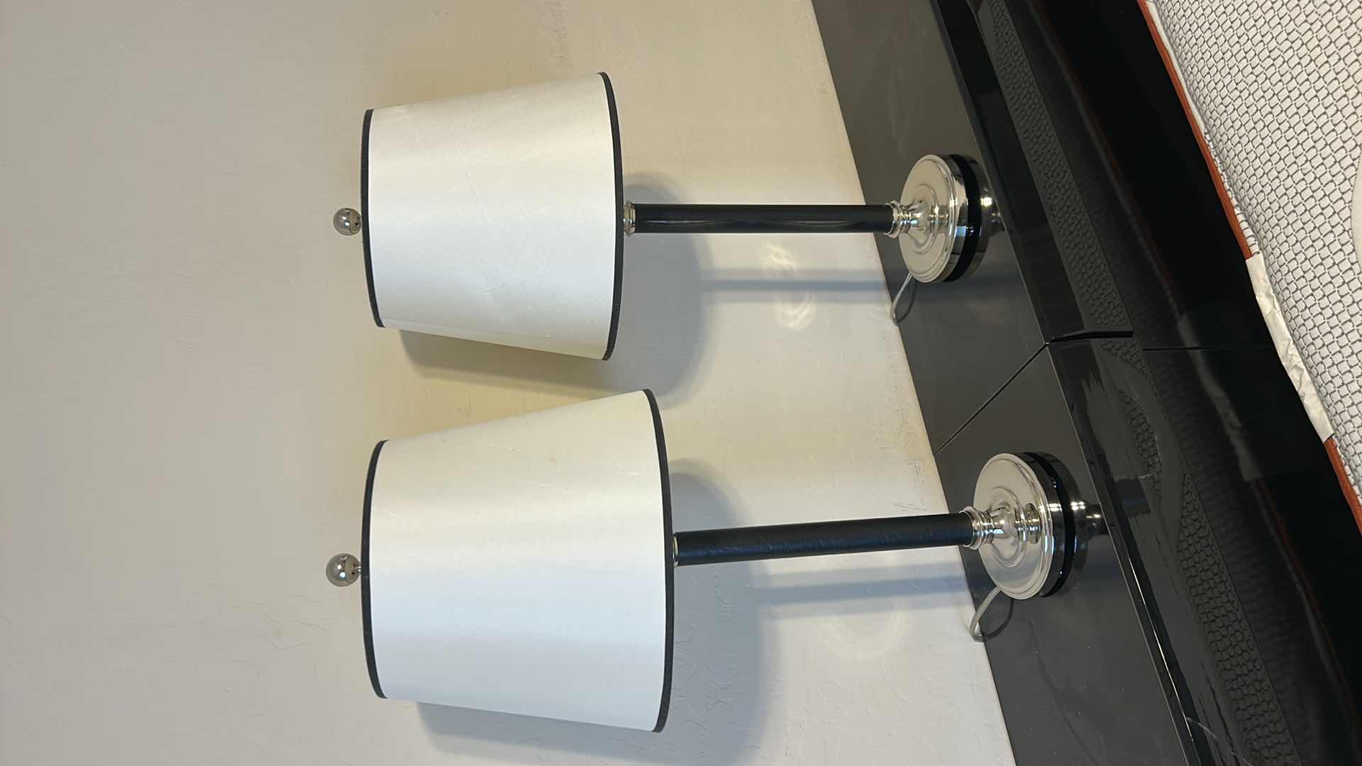 Photo 1 of 2 - BLACK LEATHER WRAPPED WITH SILVER ACCENTS AND BLACK OUTLINED WHITE SHADESTABLE LAMP  H28”