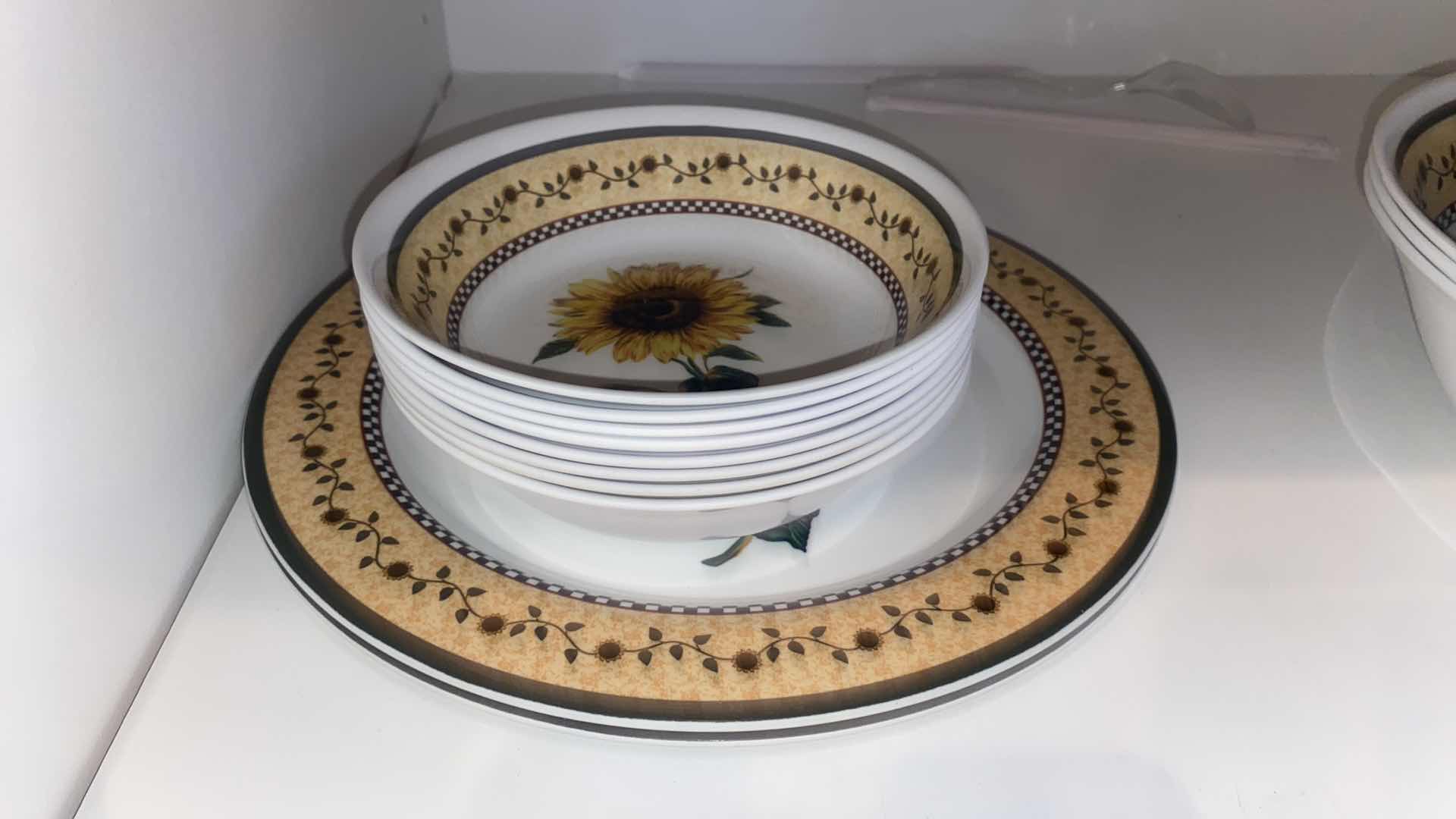 Photo 1 of CONTENTS OF CABINET - MELAMINE SUNFLOWER SERVE WARE & CERAMIC FRUIT MOTIF SERVE WARE