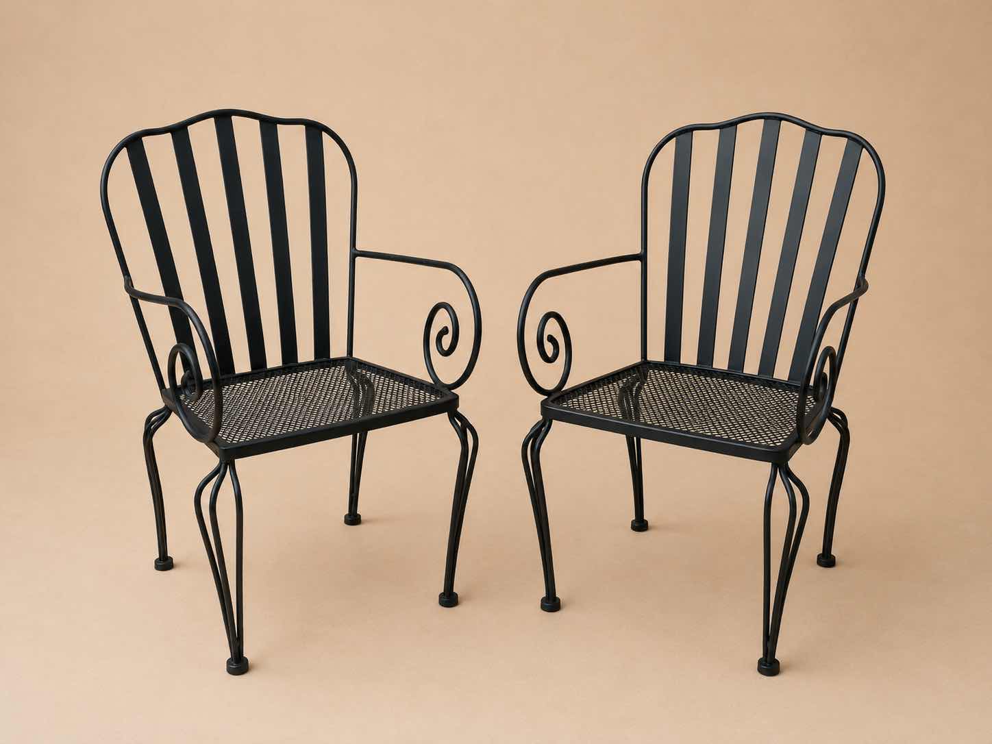 Photo 1 of 2 VINTAGE WROUGHT-IRON PATIO ARMCHAIR, FEATURING A MESH SEAT AND SCROLL ARM DETAILS $400 - $500