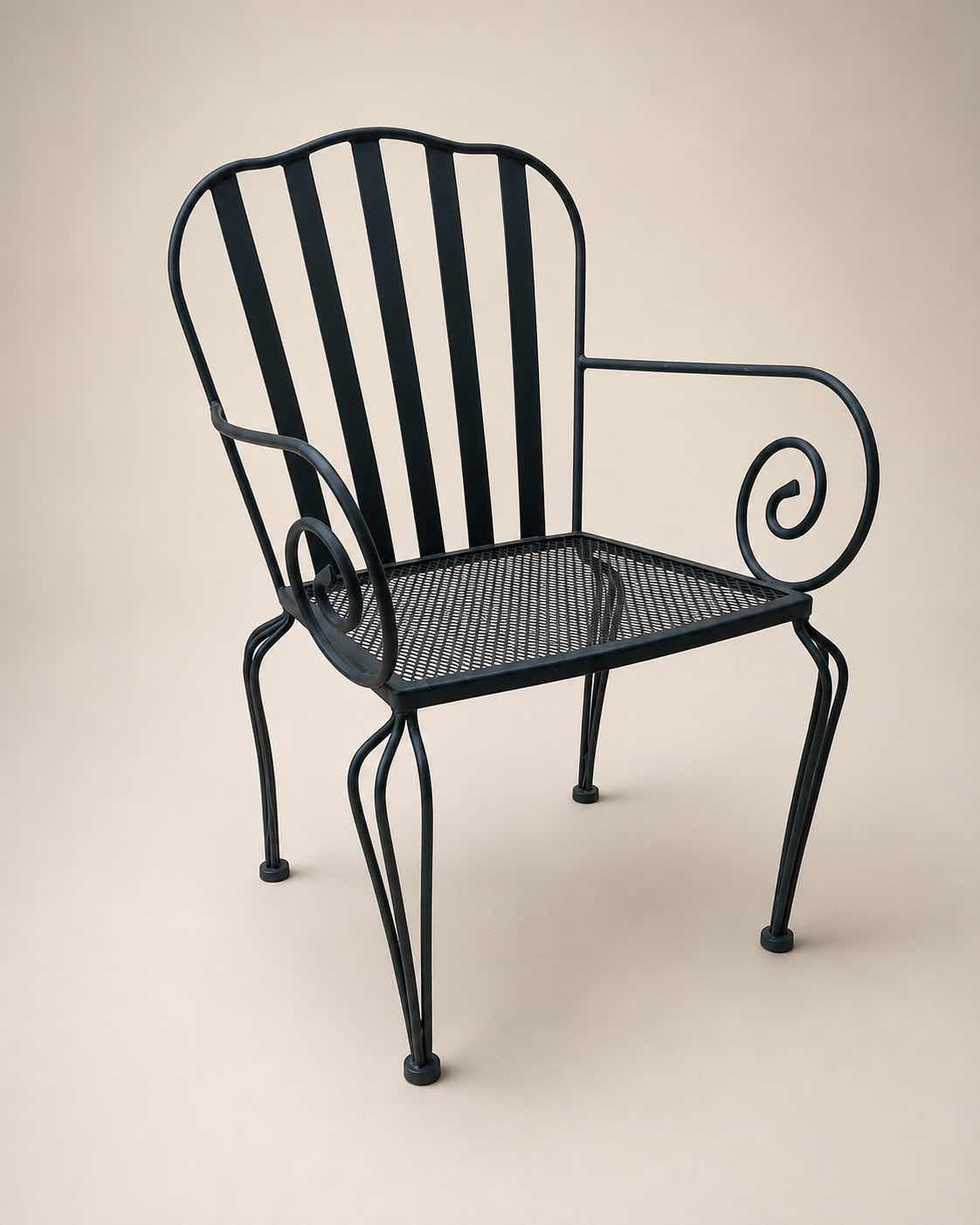 Photo 1 of 2 VINTAGE WROUGHT-IRON PATIO ARMCHAIR, FEATURING A MESH SEAT AND SCROLL ARM DETAILS $400 - $500