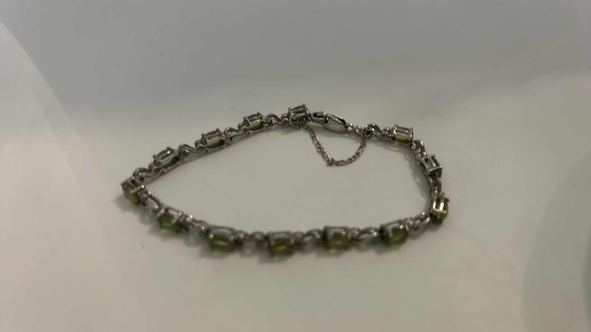Photo 1 of STERLING SILVER TENNIS BRACELET WITH GREEN GEMSTONES