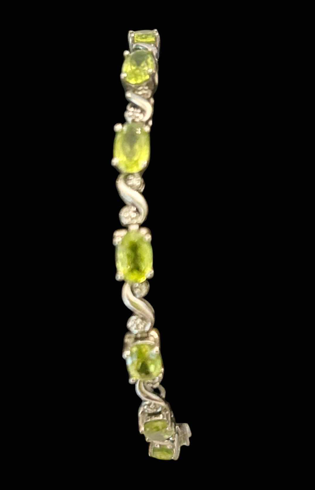 Photo 1 of STERLING SILVER TENNIS BRACELET WITH GREEN GEMSTONES