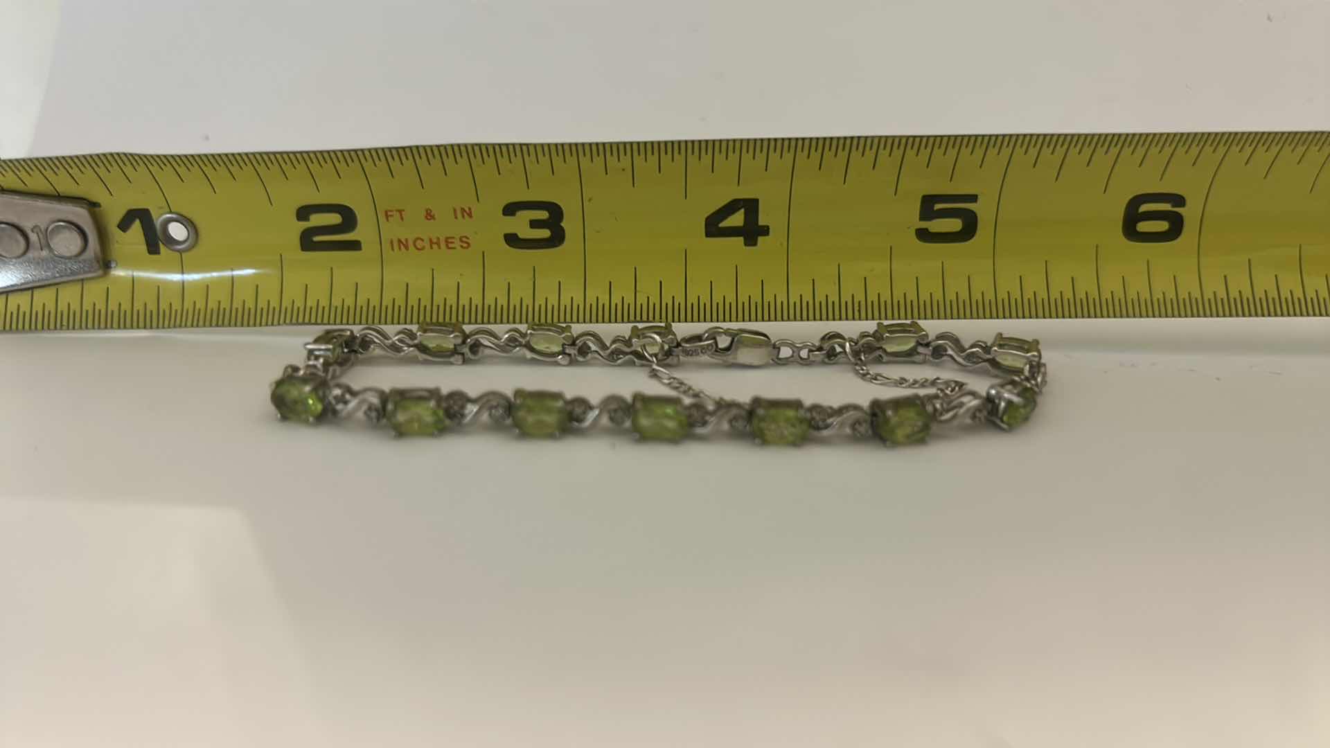 Photo 1 of STERLING SILVER TENNIS BRACELET WITH GREEN GEMSTONES