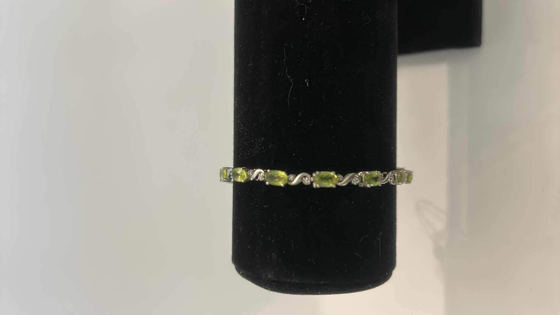 Photo 1 of STERLING SILVER TENNIS BRACELET WITH GREEN GEMSTONES