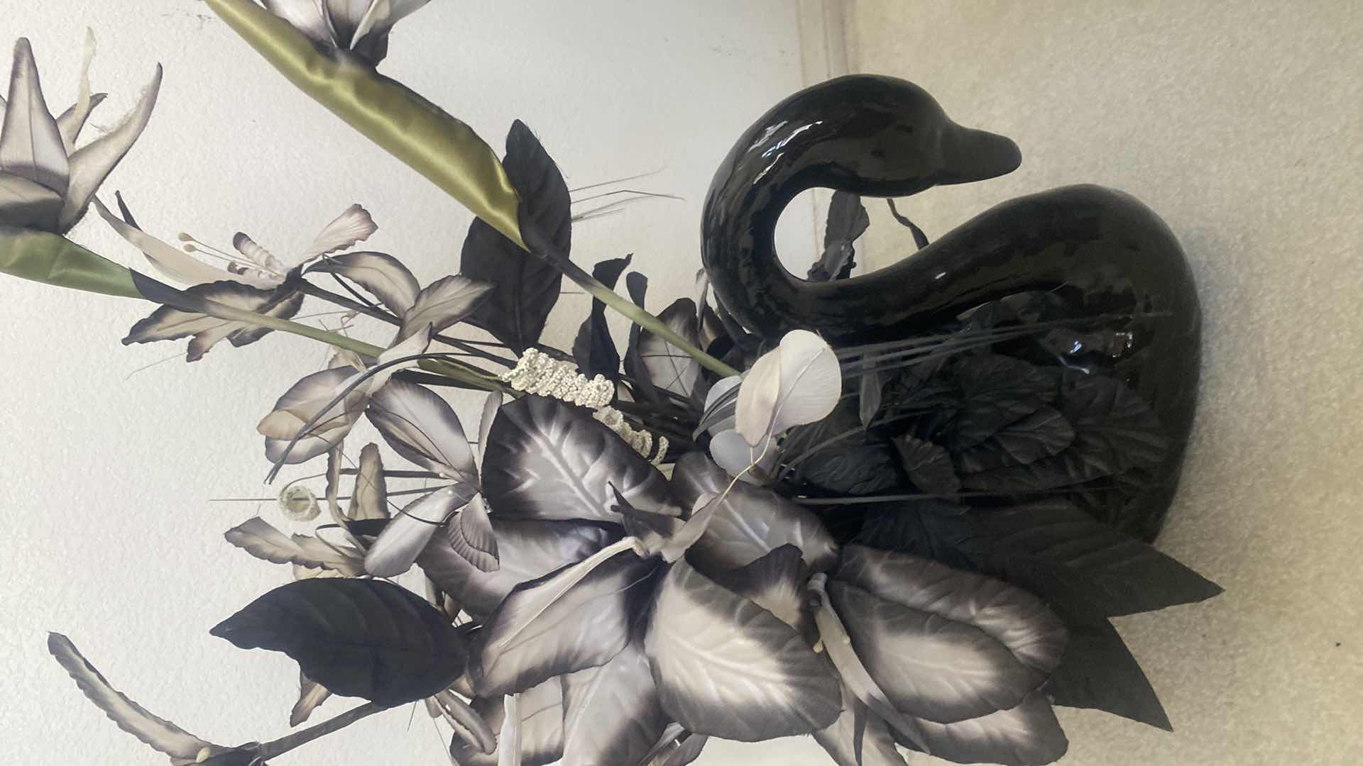 Photo 1 of BLACK CERAMIC SWAN WITH FAUX FLORALS OVERALL 19“ x 29“