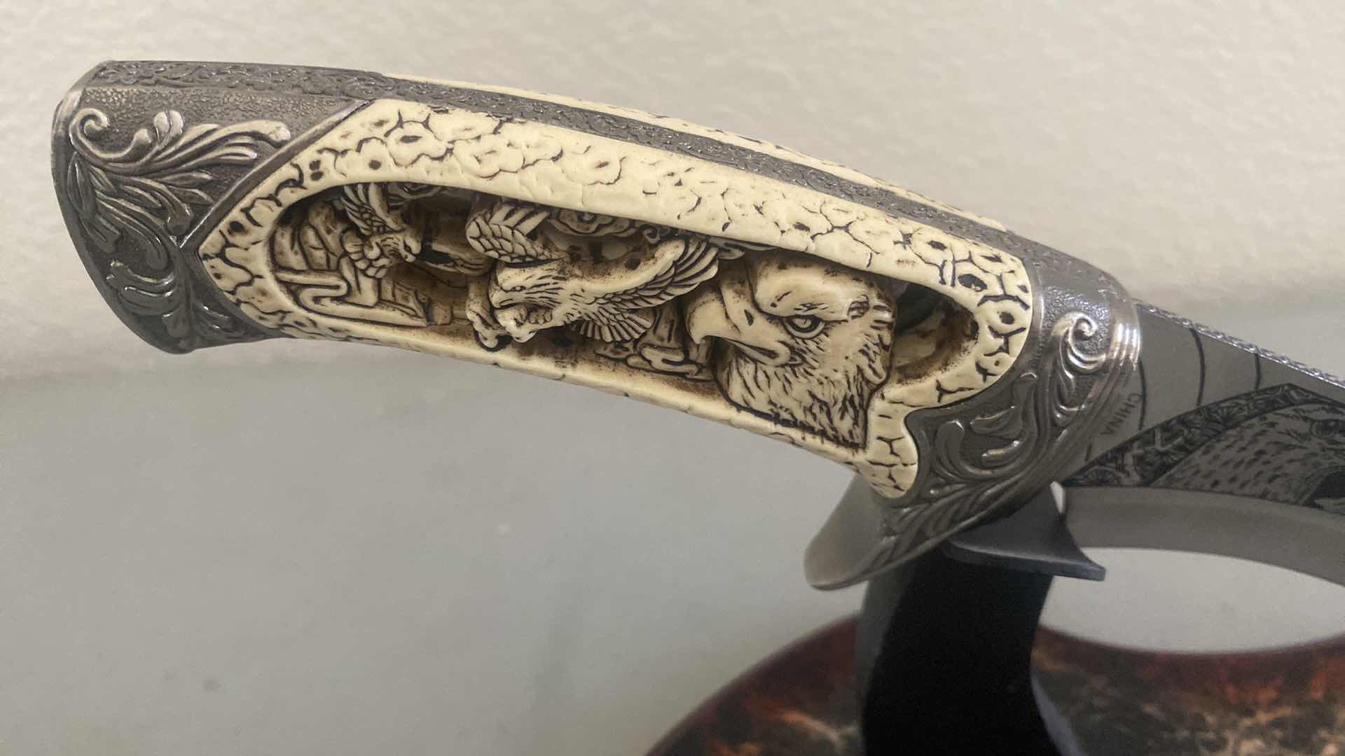 Photo 1 of CARVED HUNTING KNIFE ON STAND 12”