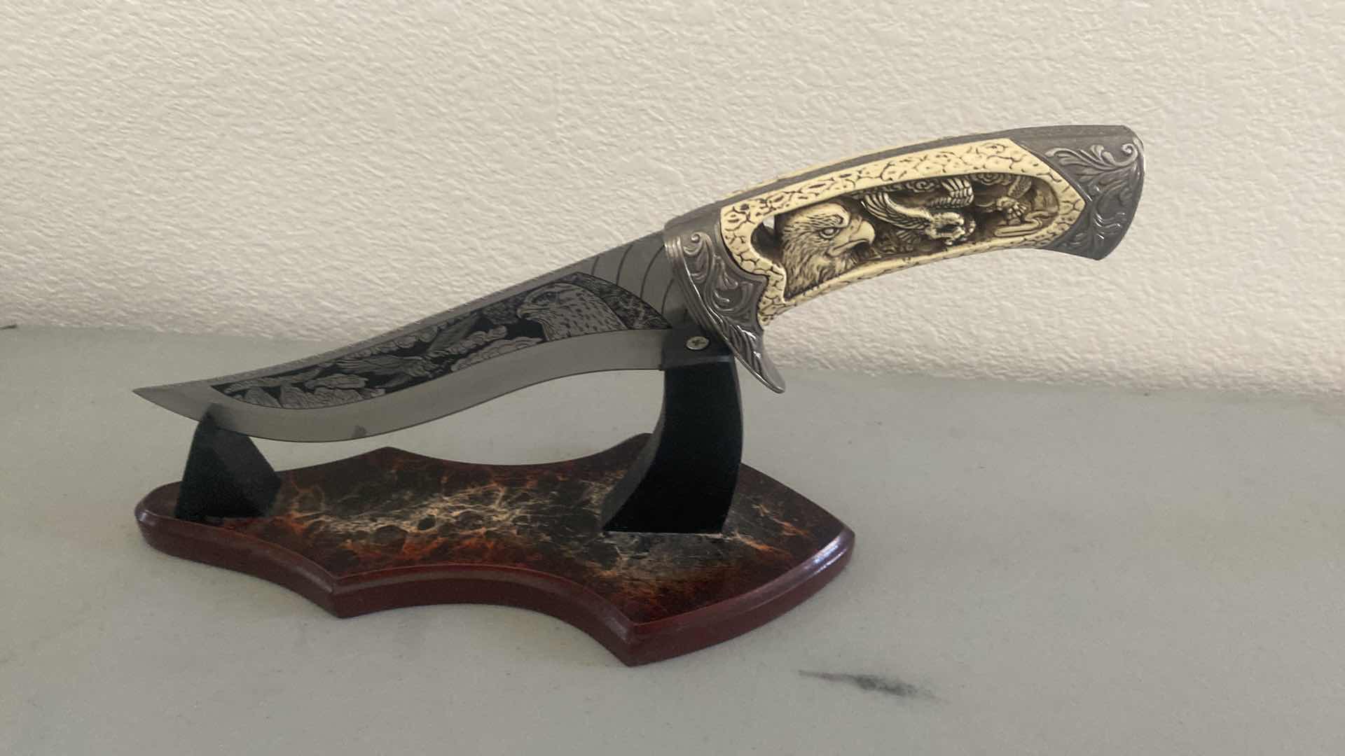 Photo 1 of CARVED HUNTING KNIFE ON STAND 12”