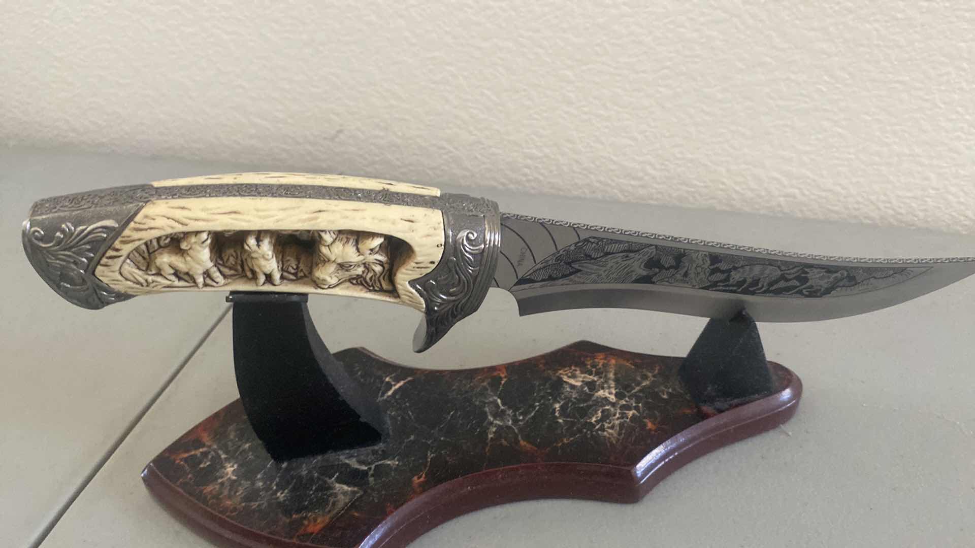 Photo 1 of CARVED HUNTING KNIFE ON STAND 12”