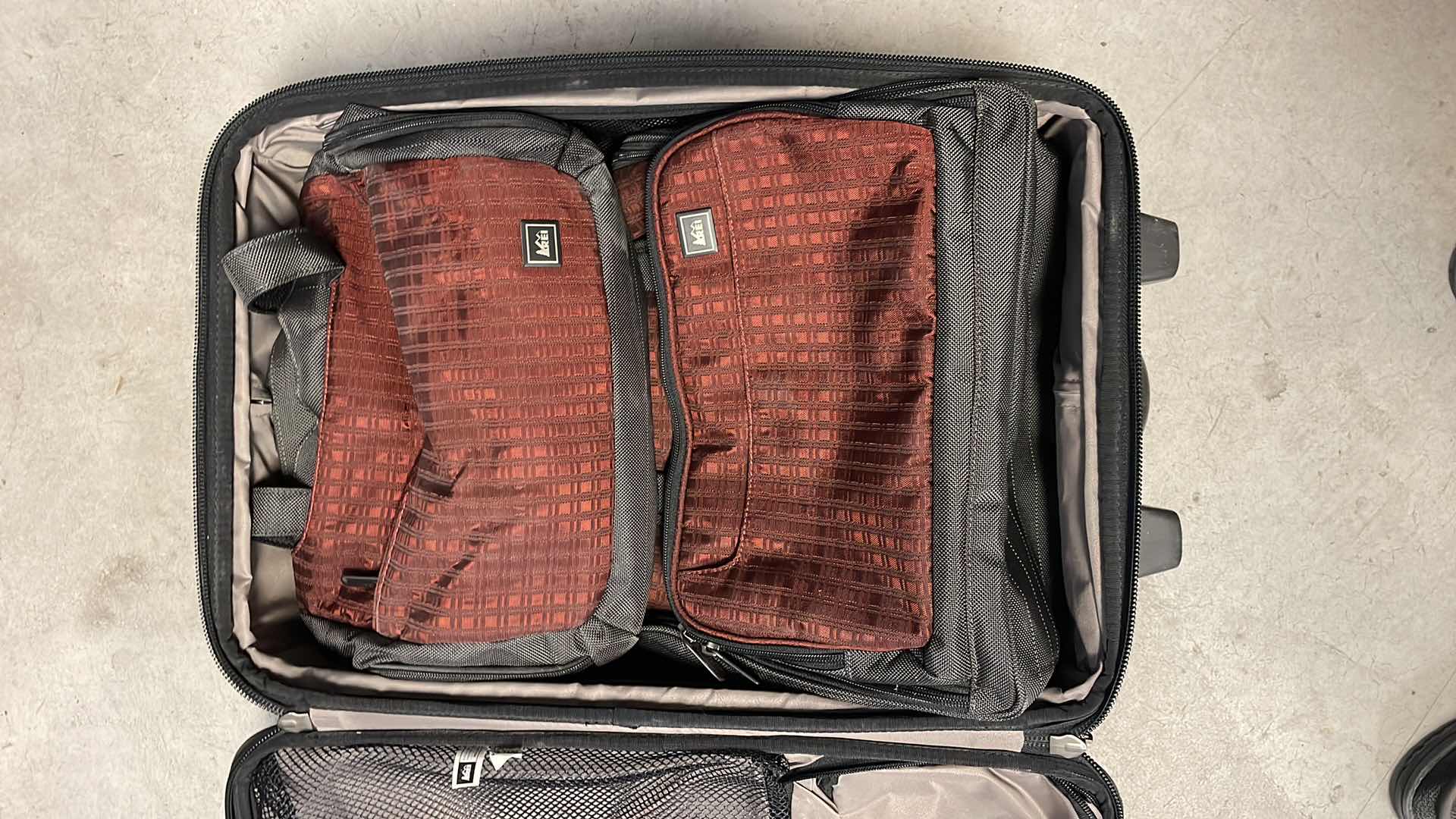 Photo 1 of REI CARRY ON SUIT CASE WITH 2 SMALLER MATCHING BAGS.