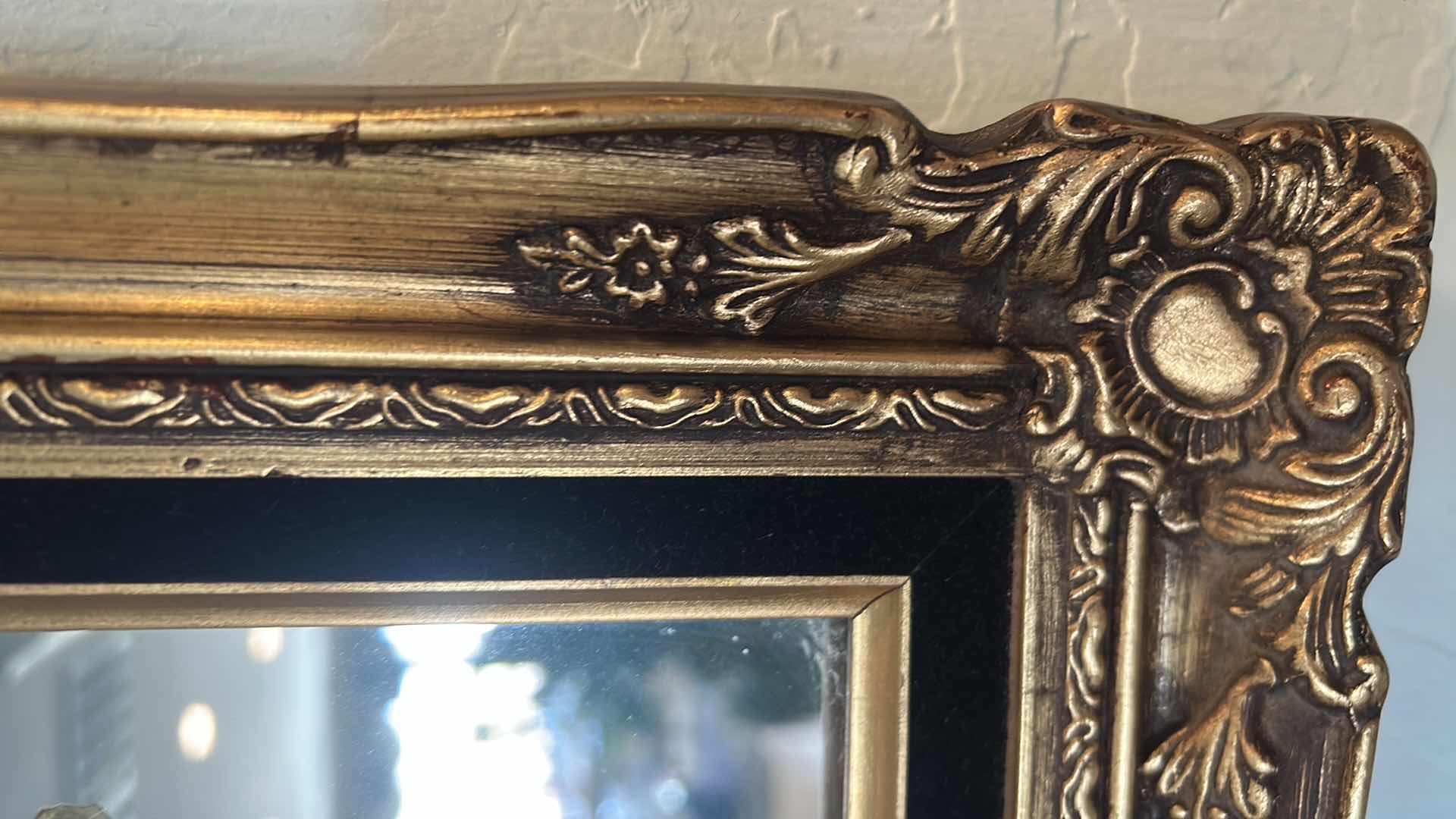 Photo 1 of DECORATIVE MIRROR W AN ORNATE GOLD COLORED FRAME AND RAISED METALLIC FLORAL 17" X 20"