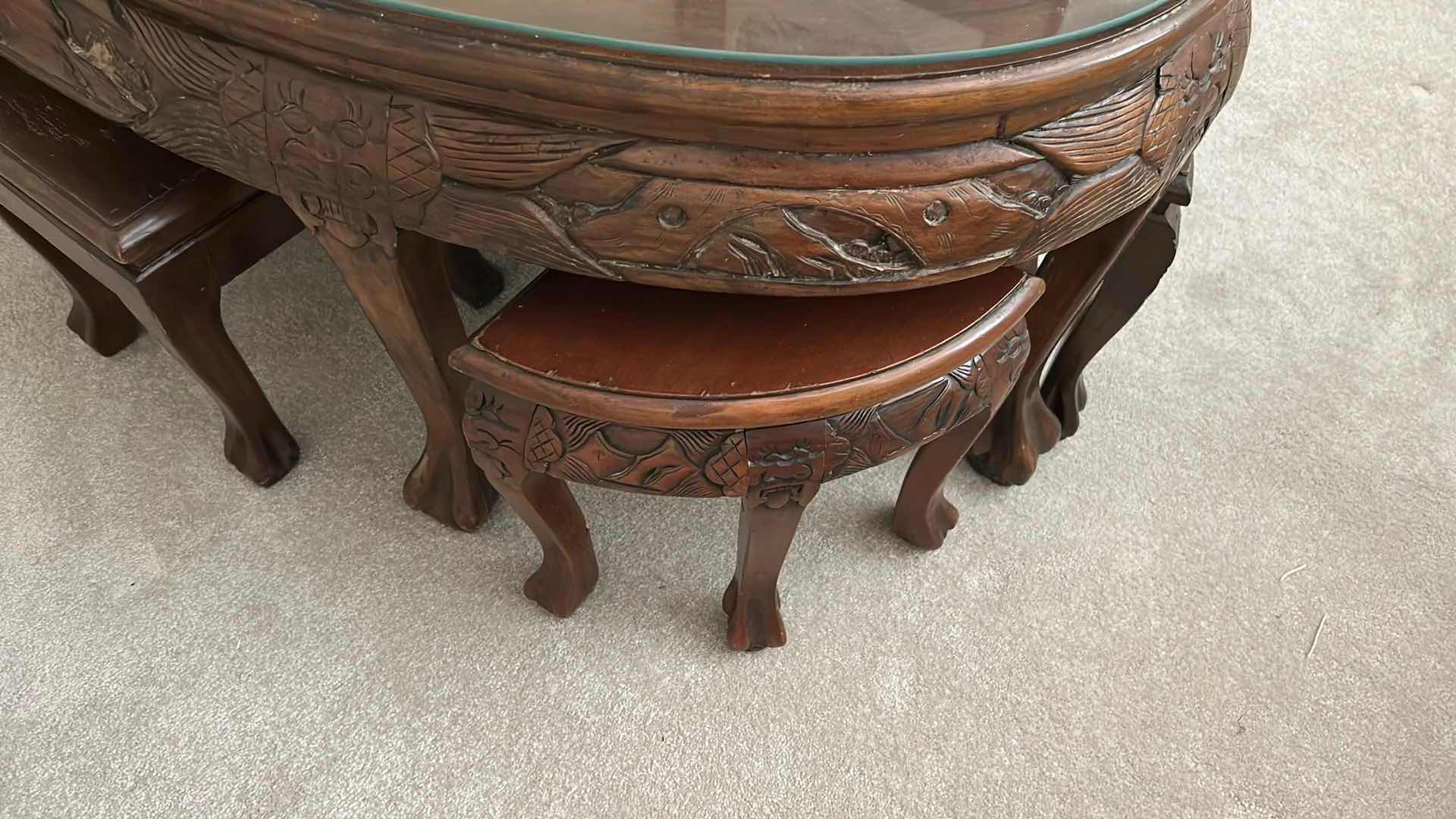 Photo 1 of ROSEWOOD CHINESE CARVED TEA TABLE W NESTING STOOLS AND GLASS TOP 47" X 29" H 22" 