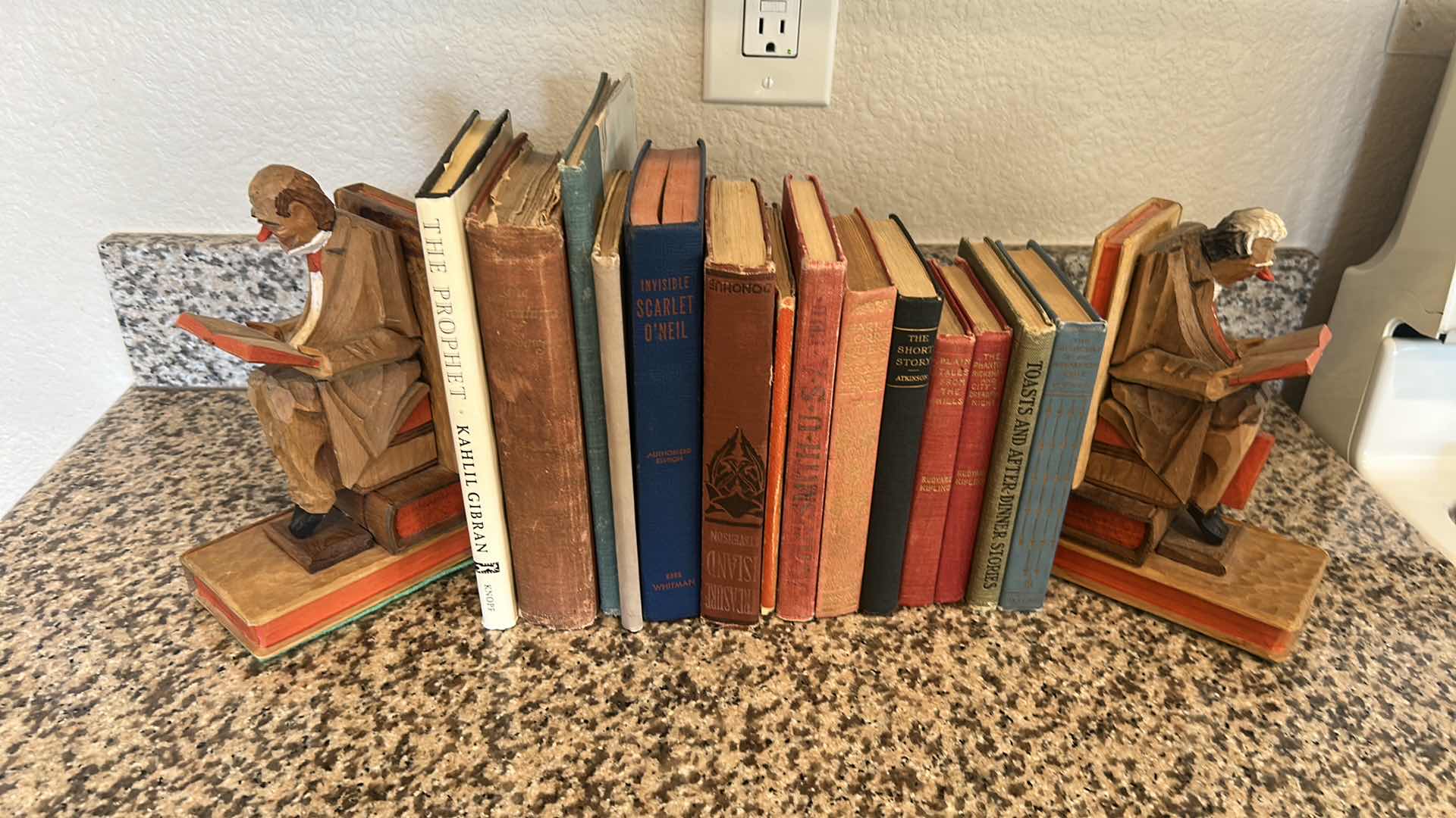 Photo 1 of TWO CARVED WOODEN BOOKENDS W 14 BOOKS