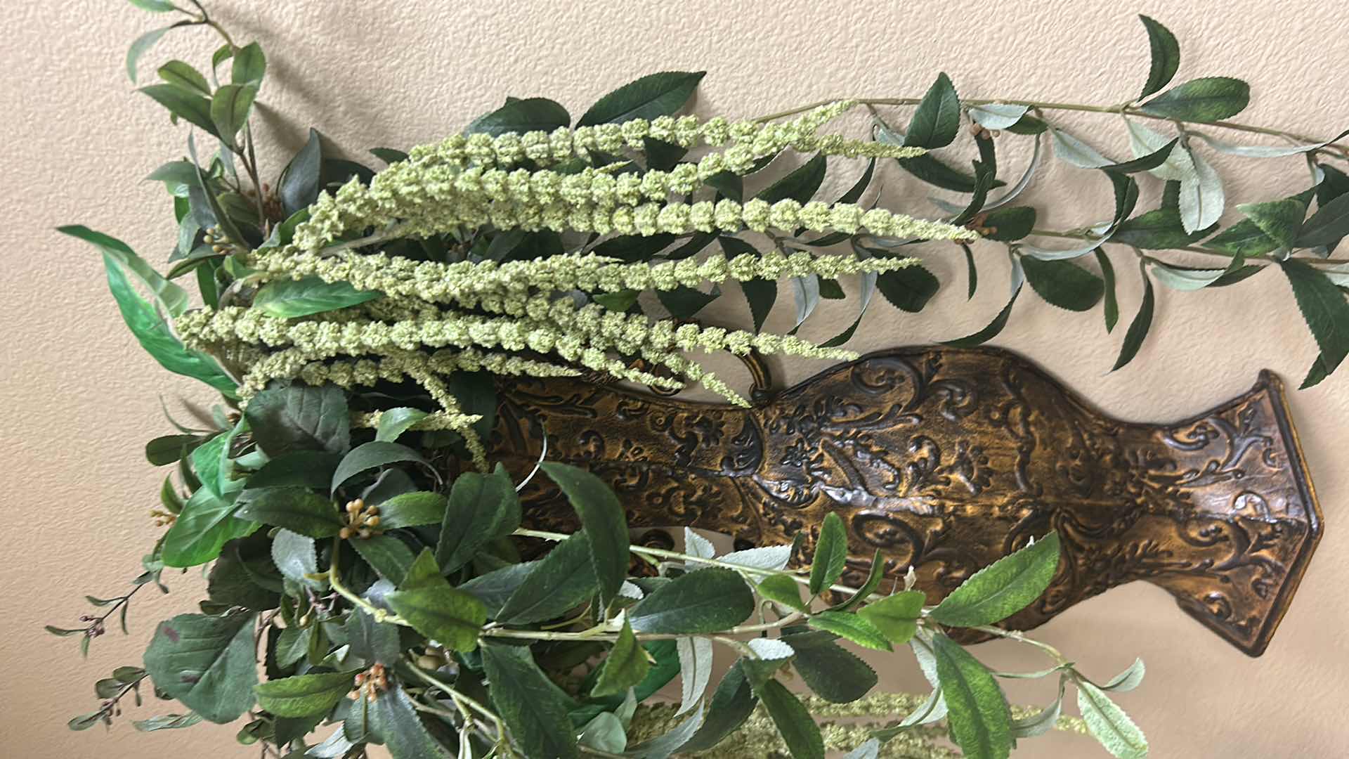 View 3 of FAUX TRAILING GREENERY IN A METAL BRONZE ORNATE WALL VASE H 25"