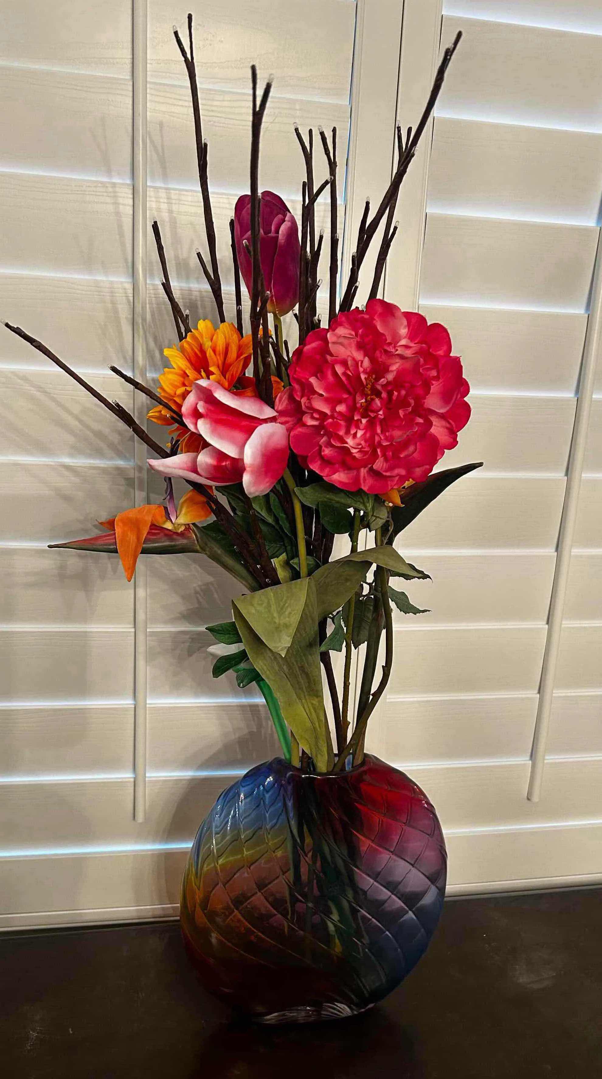 Photo 1 of DECORATIVE FLORAL ARRANGEMENT IN A MULTI COLORED GLASS VASE H 36"