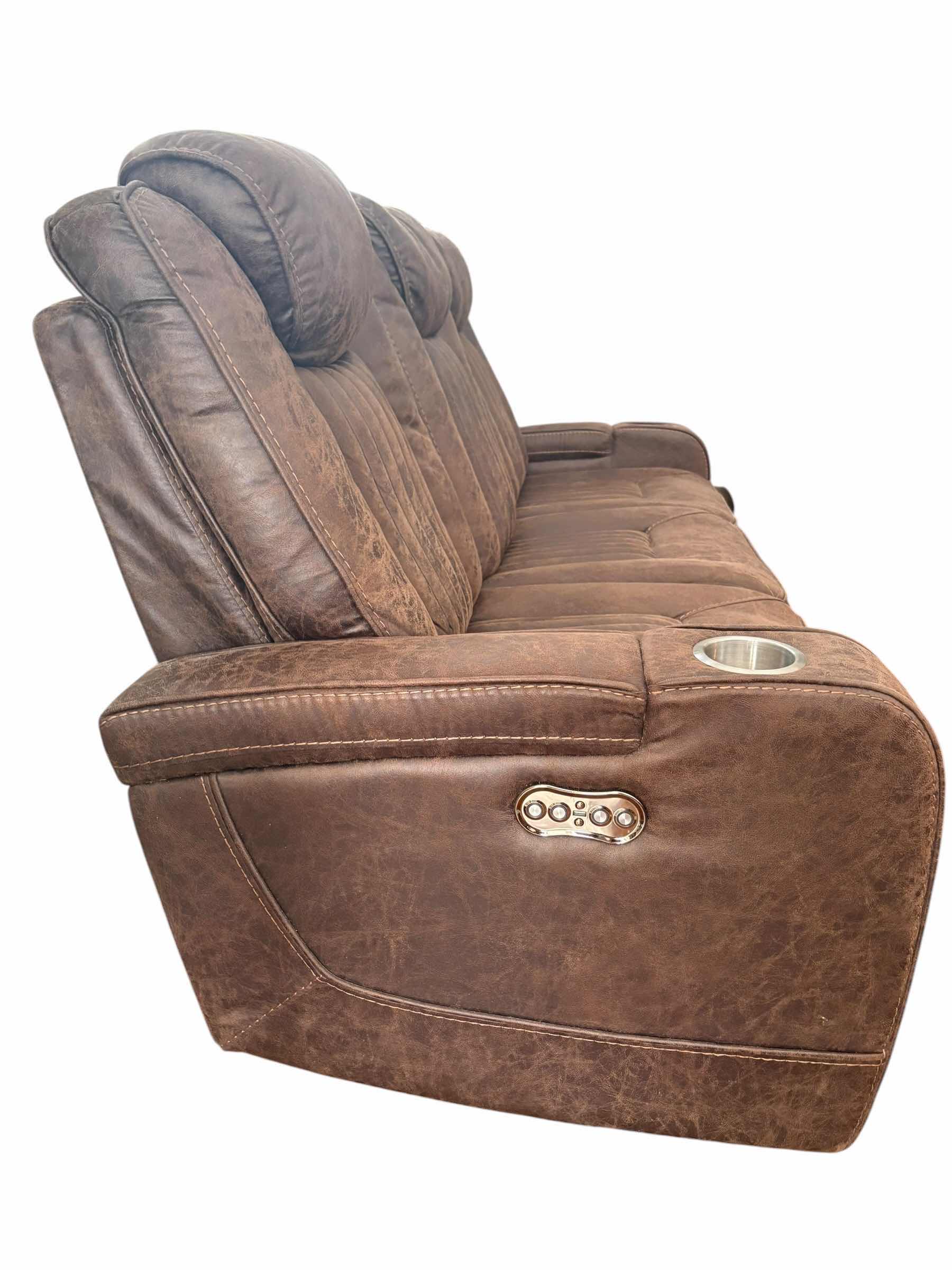 Photo 1 of BROWN LEATHER POWER SOFA RECLINER W ADJUSTABLE HEAD REST AND CUP HOLDERS 83”X34”H42.5” $3199