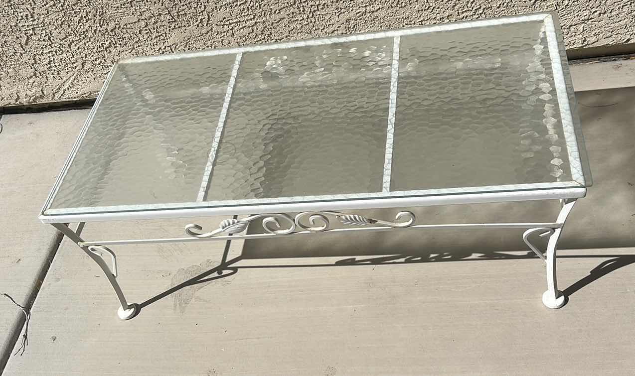 Photo 1 of WHITE WROUGHT IRON PATIO COFFEE TABLE W A GLASS TOP, OFTEN STYLED IN THE HOLLYWOOD REGENCY FASHION. 40“ X 20“ X H14 1/4“