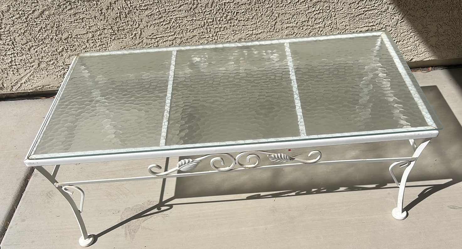 Photo 1 of WHITE WROUGHT IRON PATIO COFFEE TABLE W A GLASS TOP, OFTEN STYLED IN THE HOLLYWOOD REGENCY FASHION. 40“ X 20“ X H14 1/4“