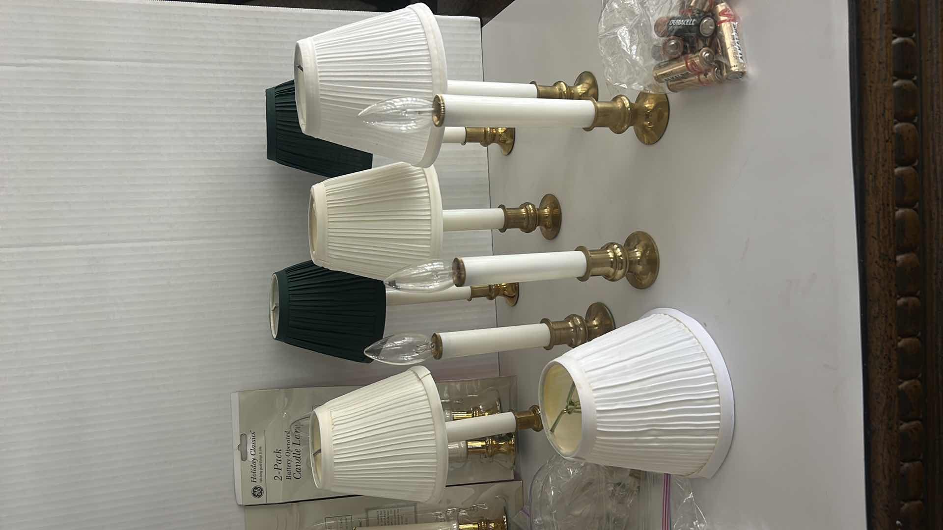 Photo 1 of BOX FULL OF BATTERY CANDLES, SMALL PLEATED SHADES FOR CANDLES, BULBS - BATTERIES