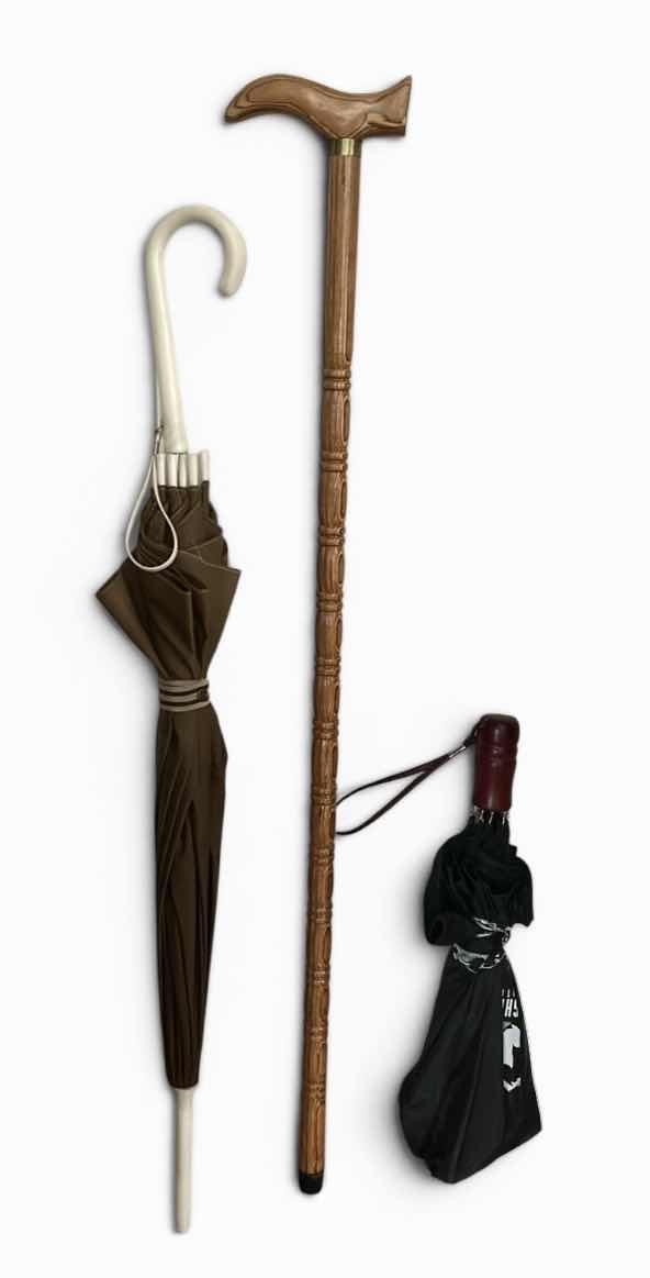 Photo 1 of WOOD CANE AND 2 UMBRELLAS